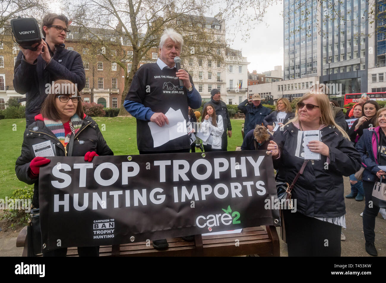 London, UK. 13th April 2014. Stanley Johnson speaks in Cavendish Square before the march through London  to a rally opposite Downing St as a part of the 2019 Global March for Elephants and Rhinos. They called on the UK government to impose a ban on the import of hunting trophies of endangered species to the UK, and supported an increase in the protection under CITES for elephants and opposed attempts to downgrade protection of endangered species or reopen trade in ivory and other body parts. Peter Marshall/Alamy Live News Stock Photo