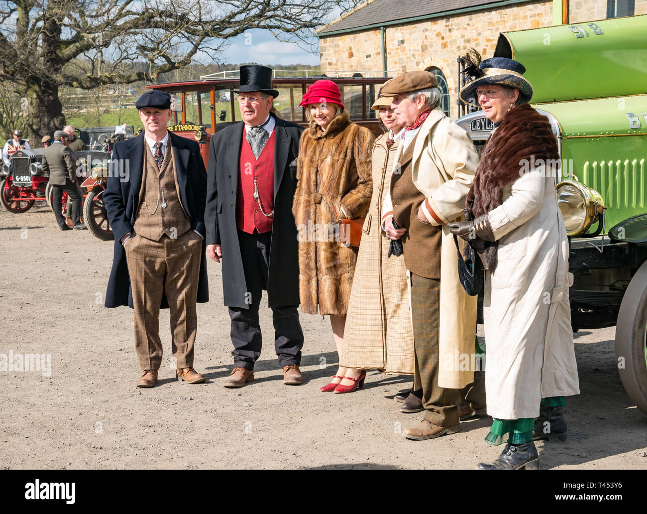 Beamish Museum, Beamish, Durham County, England, United Kingdom, 13 April 2019. Beamish Steam Day: tPeople dressed in vintage style costumes pose in front of a vintage 1921 Leyland charabus vehicle on display at Beamish Living Museum Stock Photo