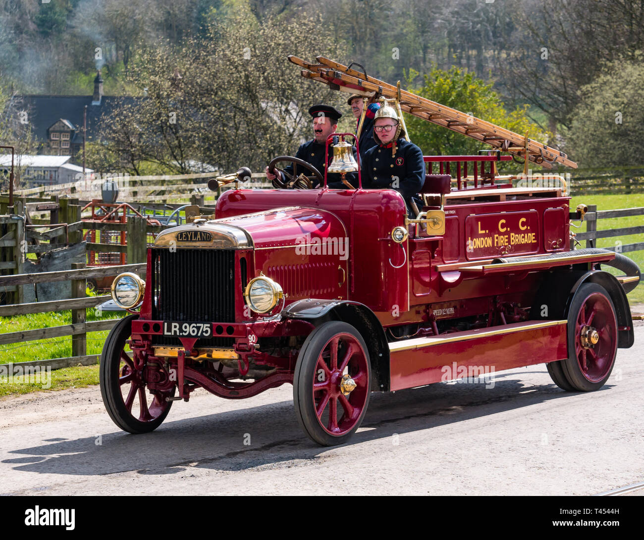Beamish, Durham County, England, United Kingdom, 13 April 2019. Beamish Steam Day: A vintage 1918 Leyland Feu4 open top fire engine vehicle with men dressed in vintage firemen costumes on display at Beamish Living Museum Stock Photo