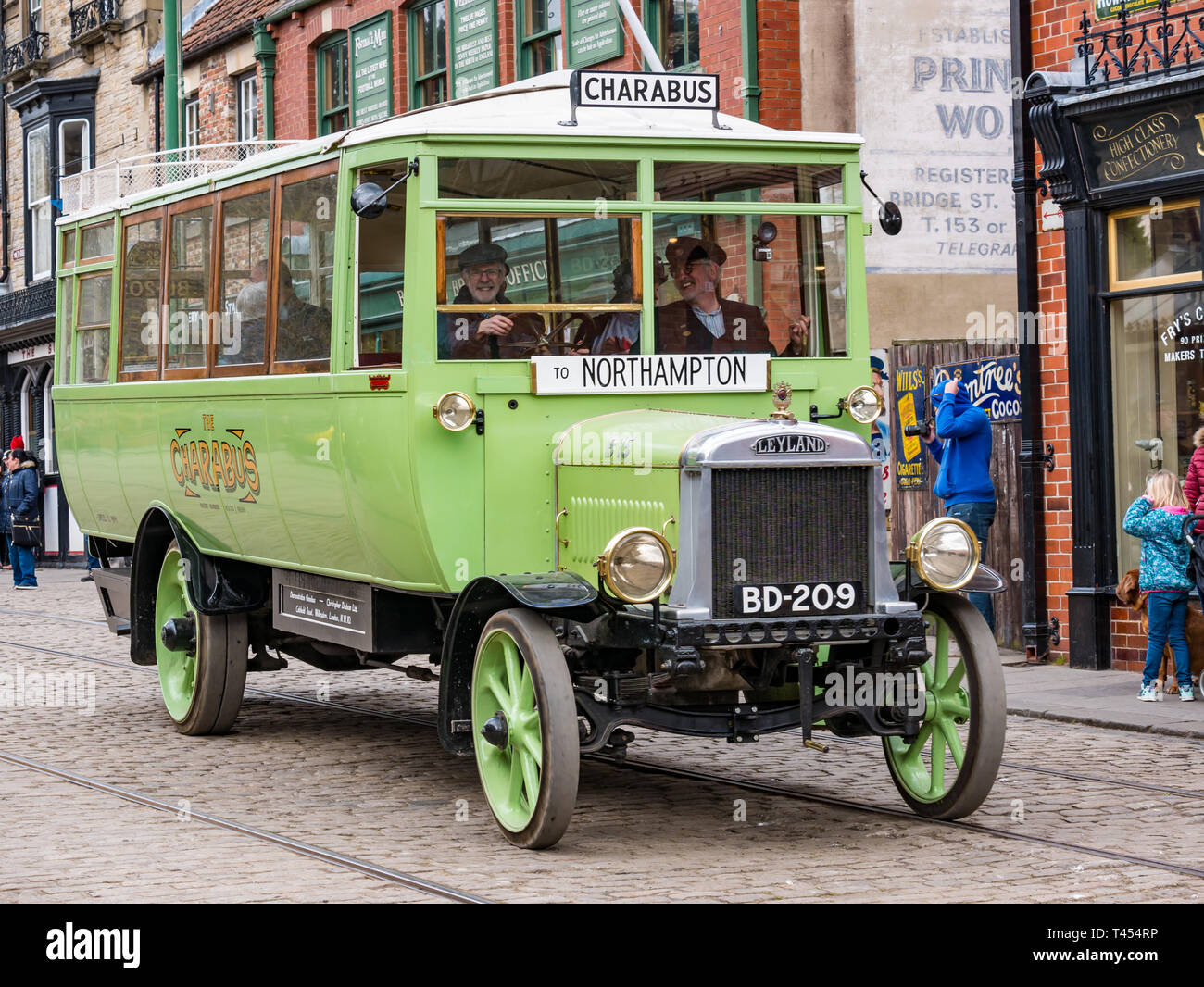 Beamish Museum, Beamish, Durham County, England, United Kingdom, 13 April 2019. Beamish Steam Day: People dressed in vintage costumes driving a vintage 1921 Leyland charabus on display at Beamish Living Museum Stock Photo
