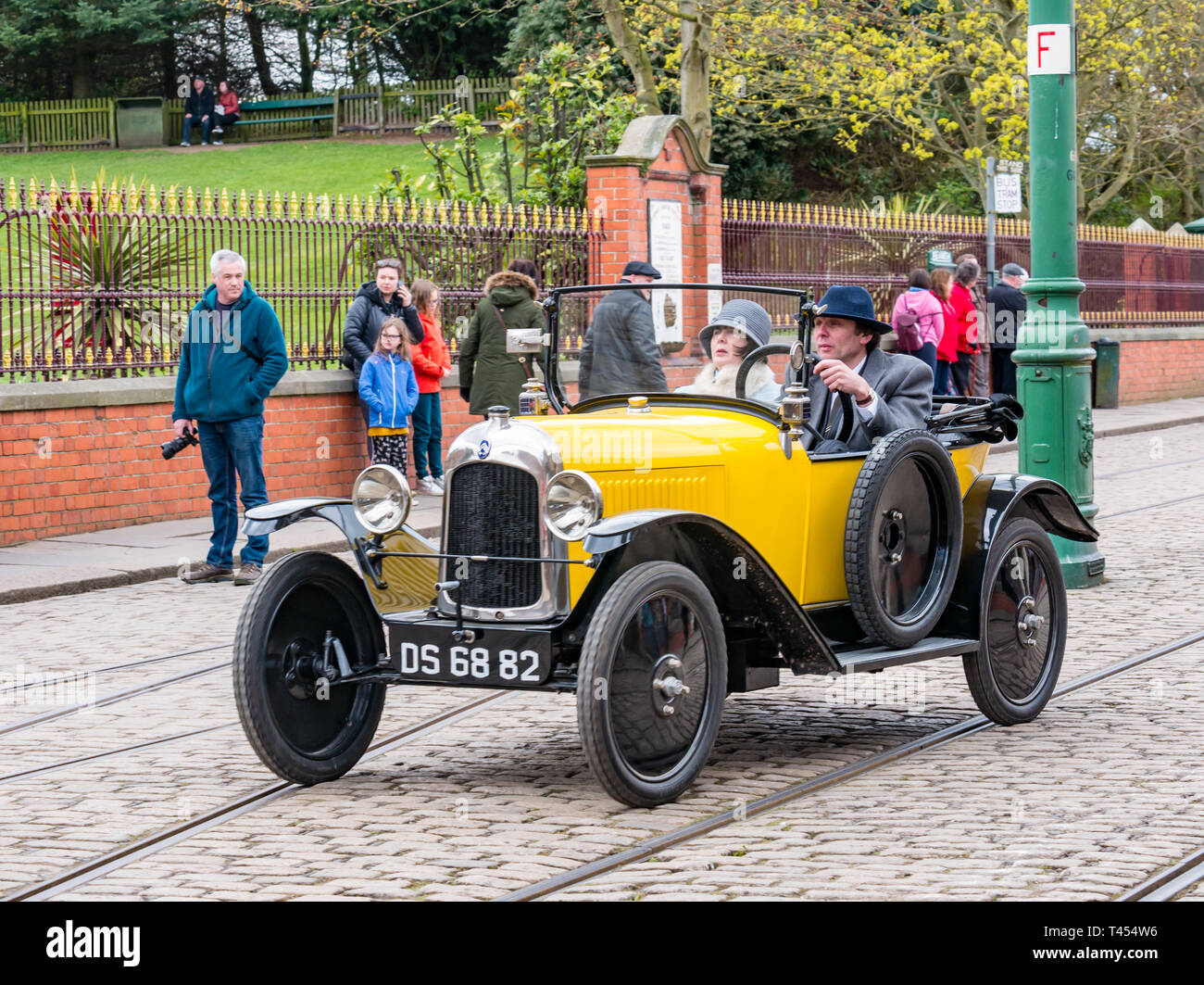 Beamish, Durham County, England, United Kingdom, 13 April 2019. Beamish Steam Day: People dressed in vintage costumes driving a vintage 1922 yellow open top Citroen car on display at Beamish Living Museum Stock Photo