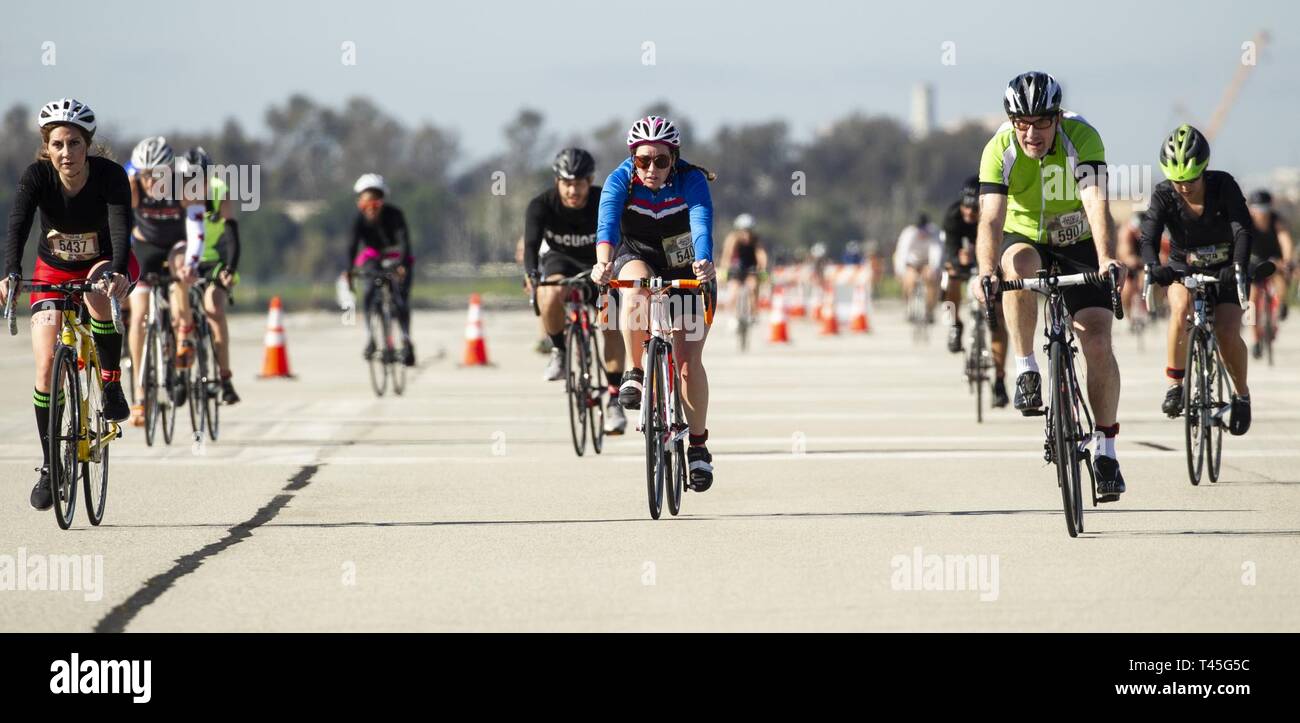 Triathletes cycle down a straightaway on Los Alamitos Army Airfield