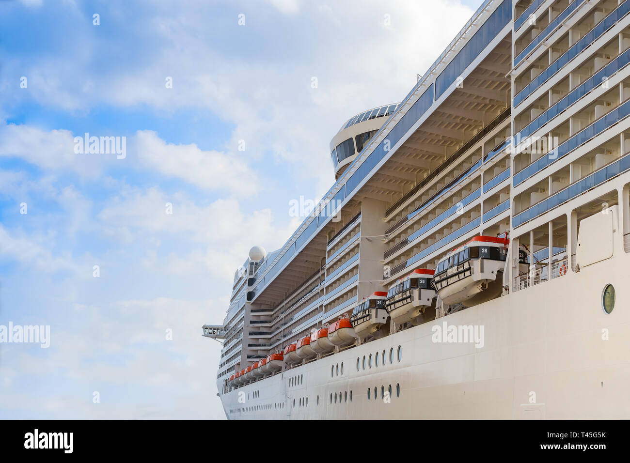 Luxury cruise liner passenger ship with lifeboats for emergency evacuation on the board side view Stock Photo