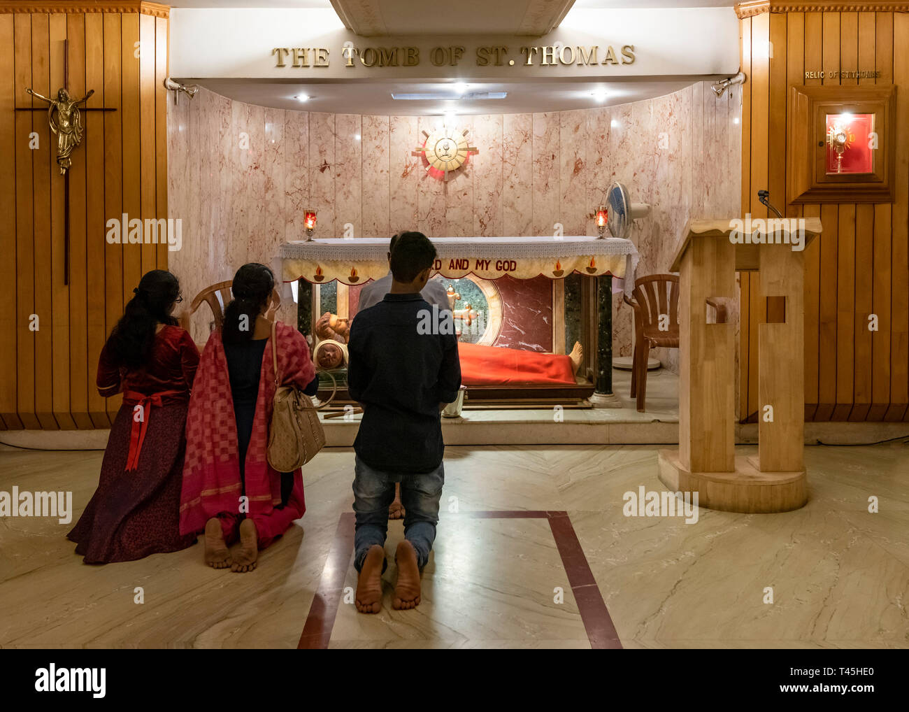Horizontal view of people praying at the tomb of St. Thomas in Chennai, India. Stock Photo