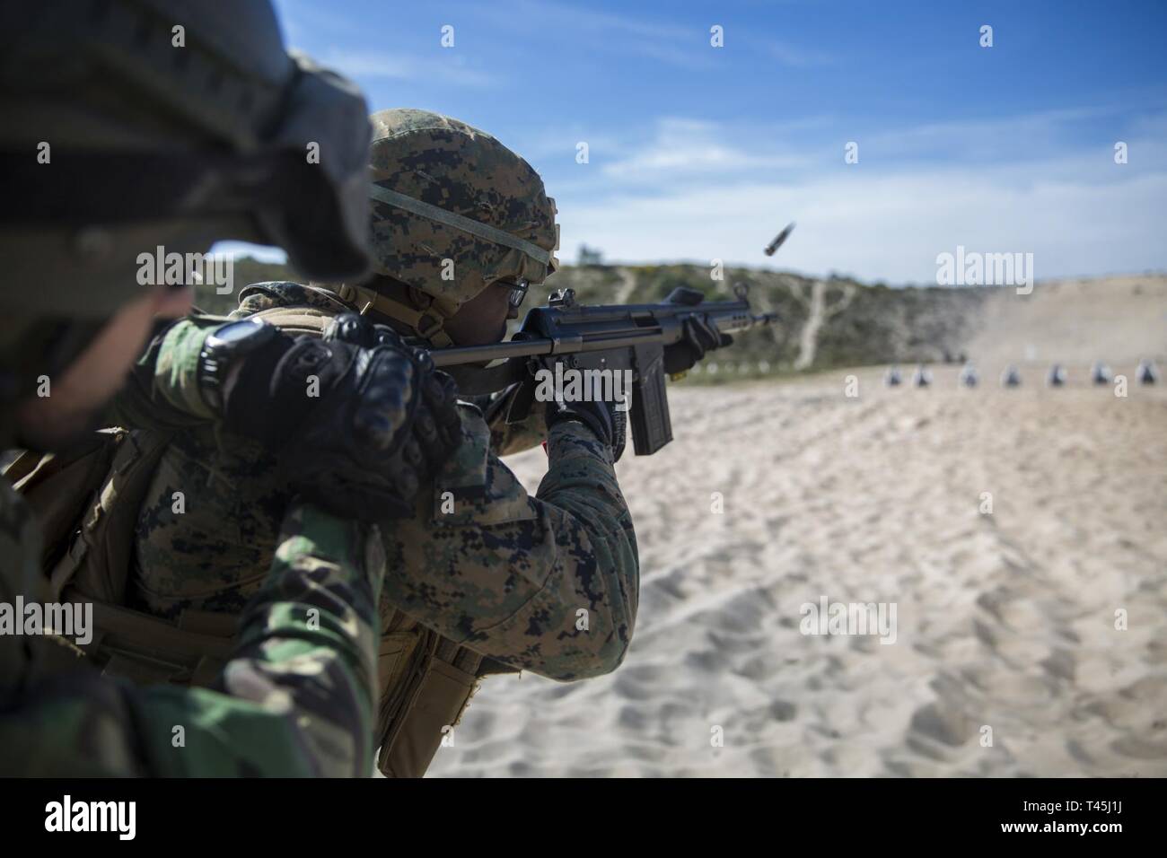 A U.S. Marine with Special Purpose Marine Air-Ground Task Force-Crisis  Response-Africa 19.1, Marine Forces Europe and Africa, fires a Portuguese  G3A3 rifle during a training event with Portuguese marines in Troia,  Portugal,