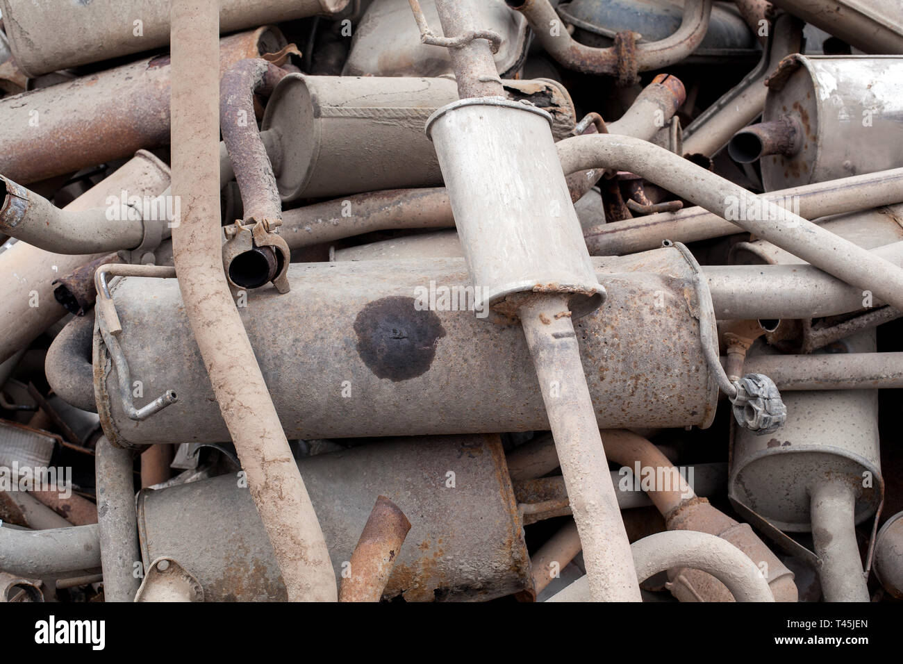 Close view pile of used mufflers at car Old car mufflers. Lot