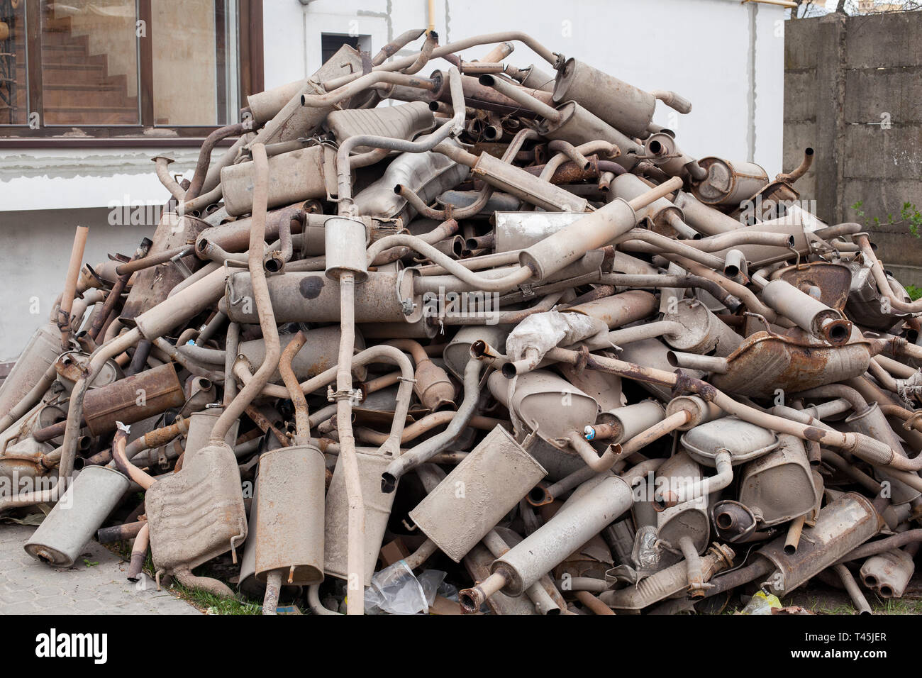 Close view pile of used mufflers at car Old car mufflers. Lot