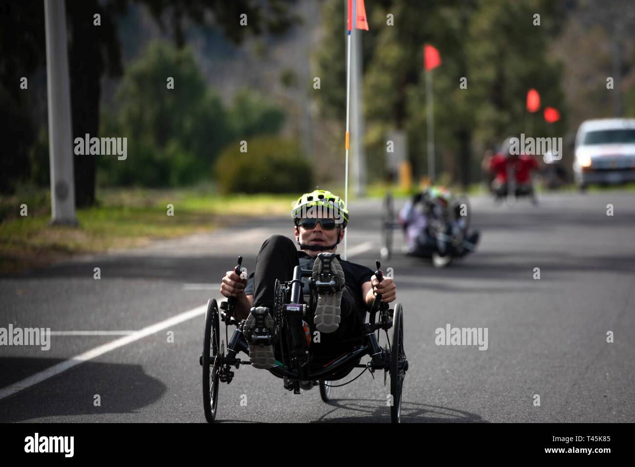 An athlete leads the way during practice for hand cycling at the 9th annual Marine Corps Trials at Marine Corps Base Camp Pendleton, California, March 1, 2019. The Marine Corps Trials promotes recovery and rehabilitation through adaptive sports participation and develops camaraderie among recovering service members and veterans. Additionally, the competition is an opportunity for participants to demonstrate physical and mental achievements and serves as the primary venue to select Marine Corps participants for the DoD Warrior Games. (Official U.S. Marine Corps Stock Photo