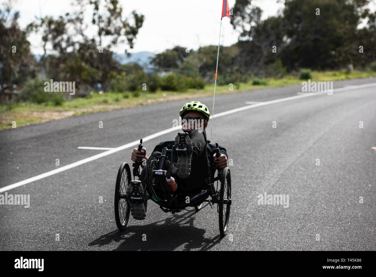 An athlete leads the way during practice for hand cycling at the 9th annual Marine Corps Trials at Marine Corps Base Camp Pendleton, California, March 1, 2019. The Marine Corps Trials promotes recovery and rehabilitation through adaptive sports participation and develops camaraderie among recovering service members and veterans. Additionally, the competition is an opportunity for participants to demonstrate physical and mental achievements and serves as the primary venue to select Marine Corps participants for the DoD Warrior Games. (Official U.S. Marine Corps Stock Photo