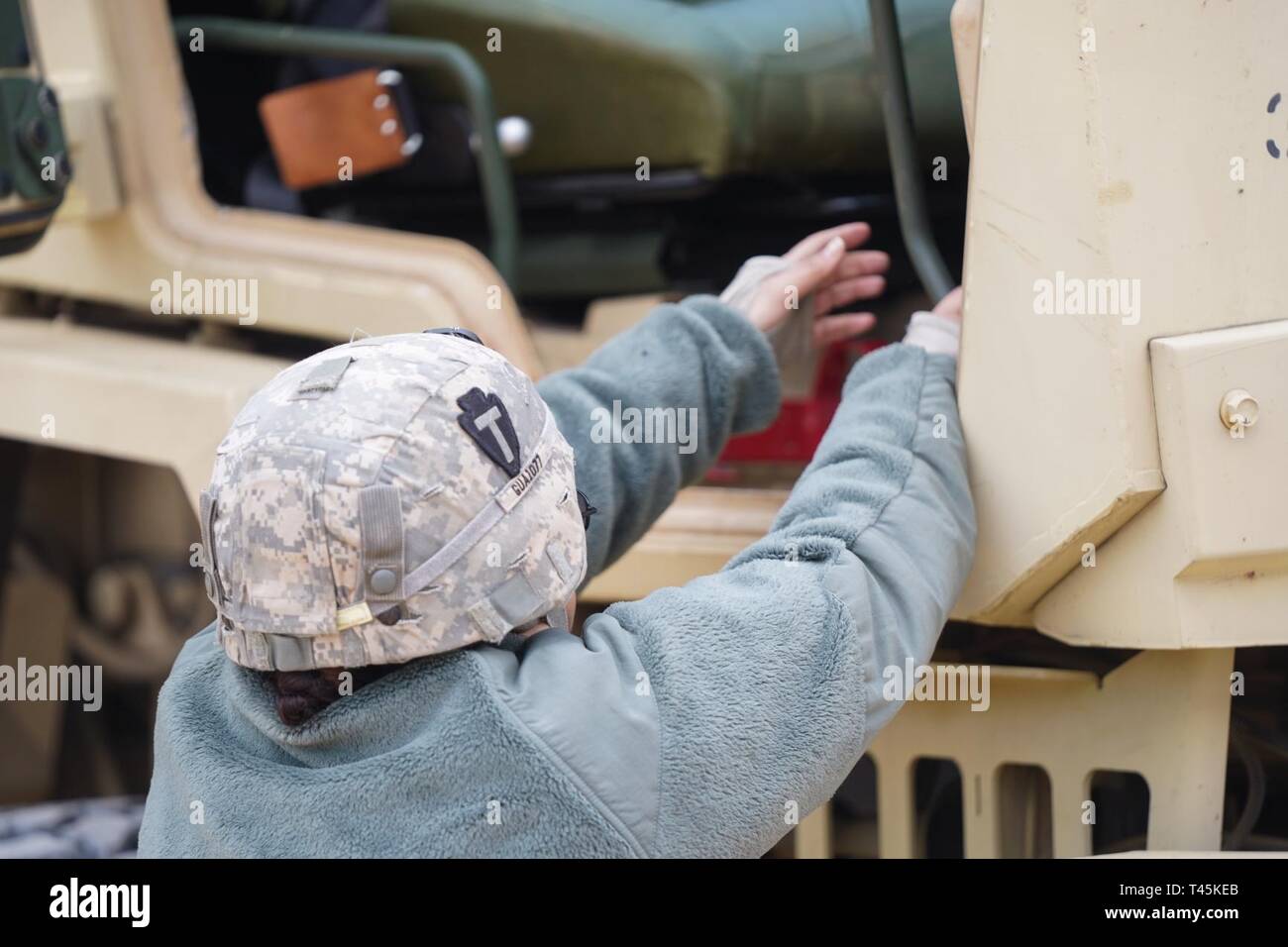 A 72nd Infantry Brigade Combat Team Soldier gets into an LMTV or Light
