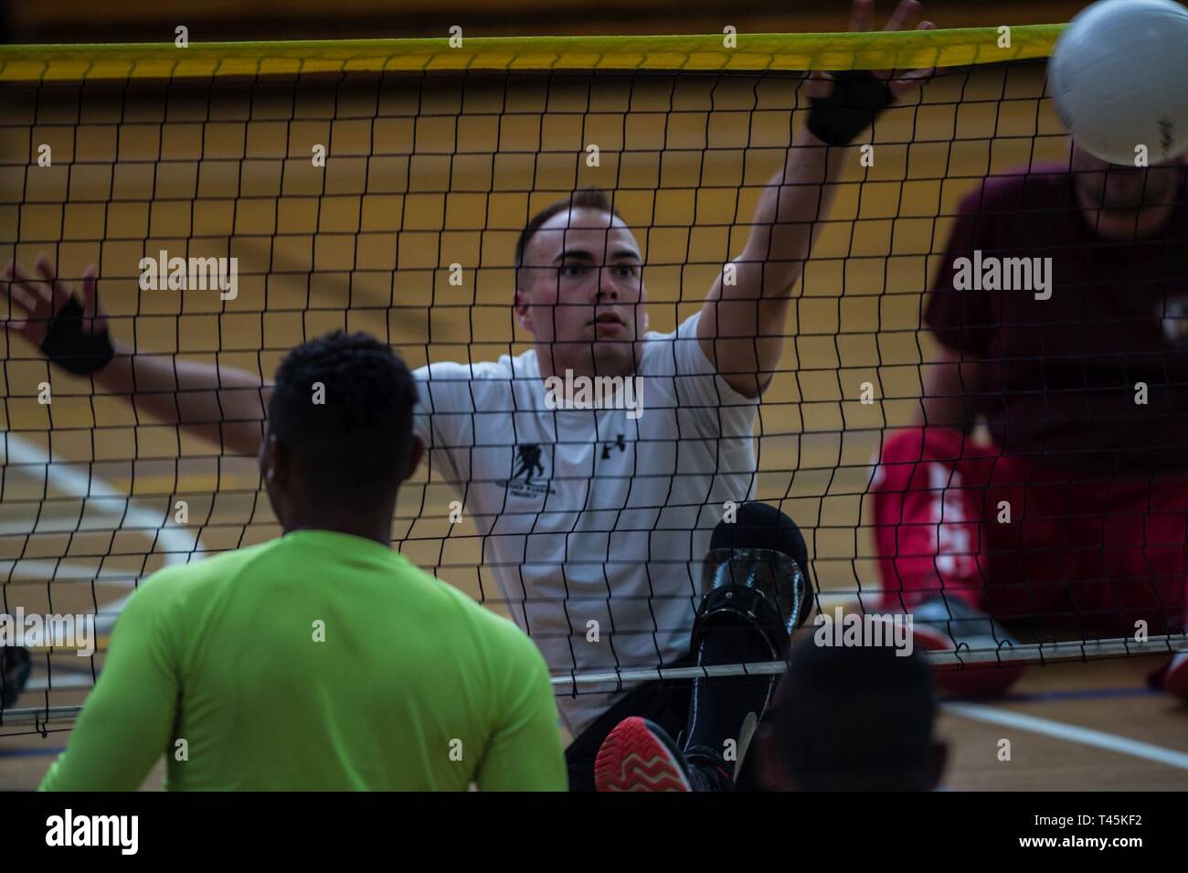 A U.S. Marine Corps athlete prepares to block during a 2019 Marine Corps Trials sitting volleyball practice session at Marine Corps Base Camp Pendleton, California, March 1. The Marine Corps Trials promotes recovery and rehabilitation through adaptive sports participation and develops camaraderie among recovering service members and veterans. Additionally, the competition is an opportunity for participants to demonstrate physical and mental achievements and serves as the primary venue to select Marine Corps participants for the DoD Warrior Games. Stock Photo