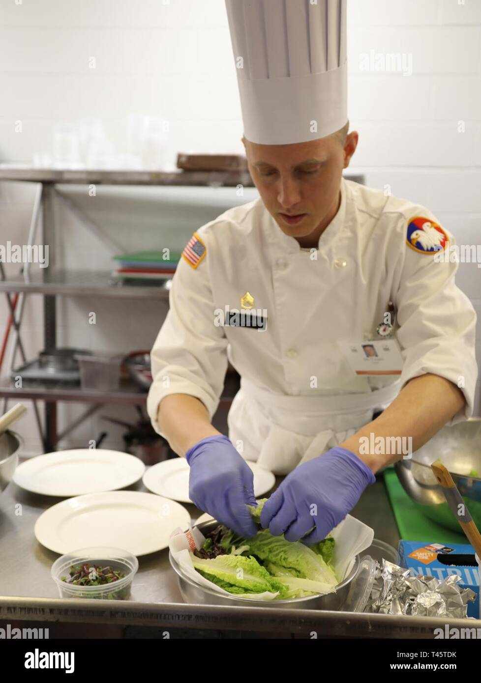 Staff Sgt. Jeffrey Vaughan, culinary arts specialist, U.S. Army Military Intelligence Readiness Command, Army Reserves, prepares lettuce for plating during the Armed Forces Chef of the Year event March 8 at the Joint Center of Culinary Excellence as part of the Joint Culinary Training Exercise at Fort Lee, Va. The 44th annual JCTE officially starts March 9 at MacLaughlin Fitness Center and continues until March 14. The exercise, administered by the Joint Culinary Center of Excellence, is the largest American Culinary Federation-sanctioned competition in North America. The exercise showcased th Stock Photo