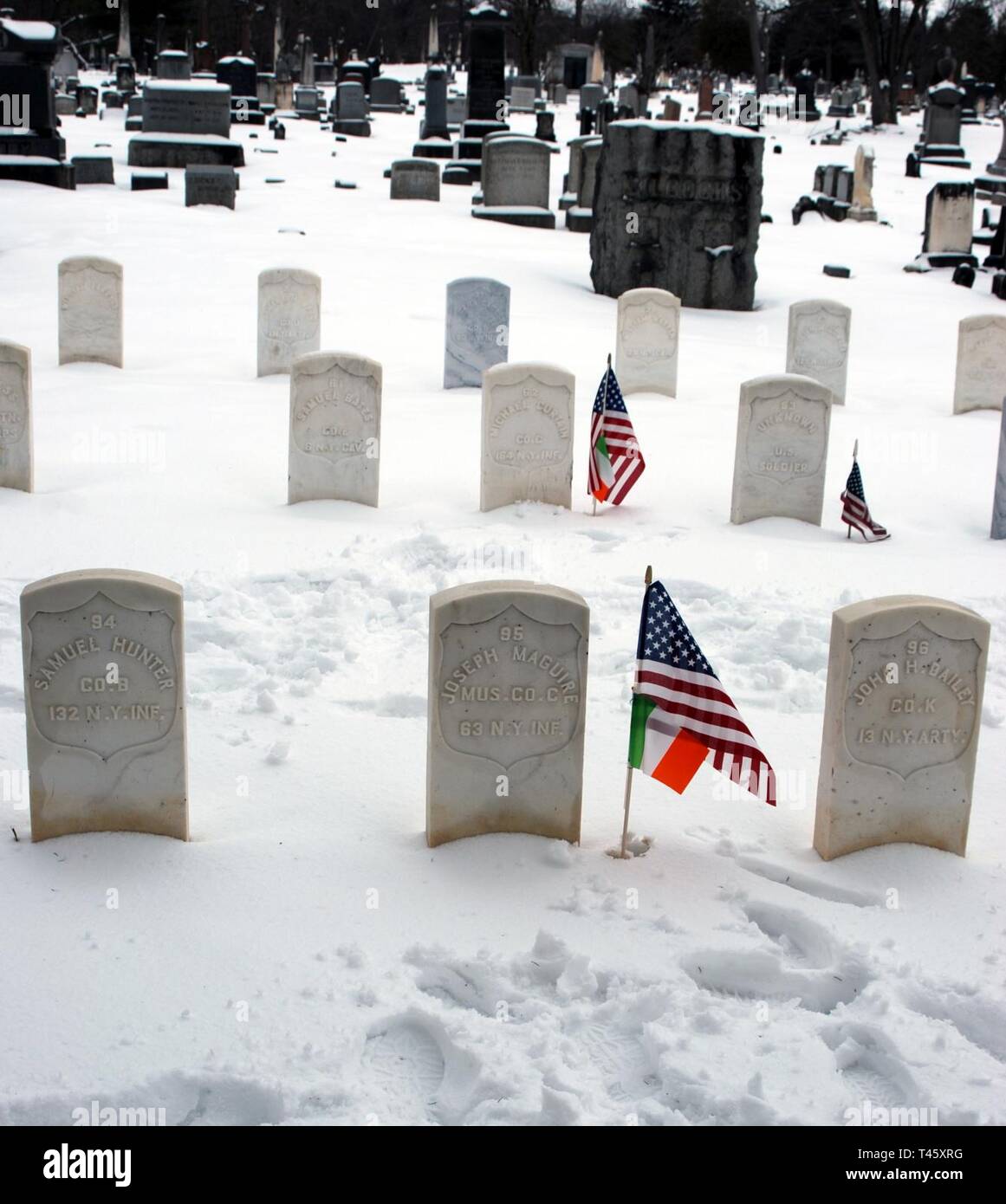 American and Irish flags mark the graves of Civil War veterans who served in the Irish Brigade at the Soldiers Lot in Albany Rural Cemetery on March 10, 2019. Veterans of the New York National Guard's 1st  Battalion 69th Infantry who live in the Albany, N.Y.- area marked the graves of Irish-American Civil War Soldiers at Albany Rural Cemetery and St. Agnes Catholic Cemetery to acknowledge the link between their service and the 69th Infantry, which was historically an Irish-American unit and part of the Irish Brigade during the war. ( U.S. Army National Guard Stock Photo