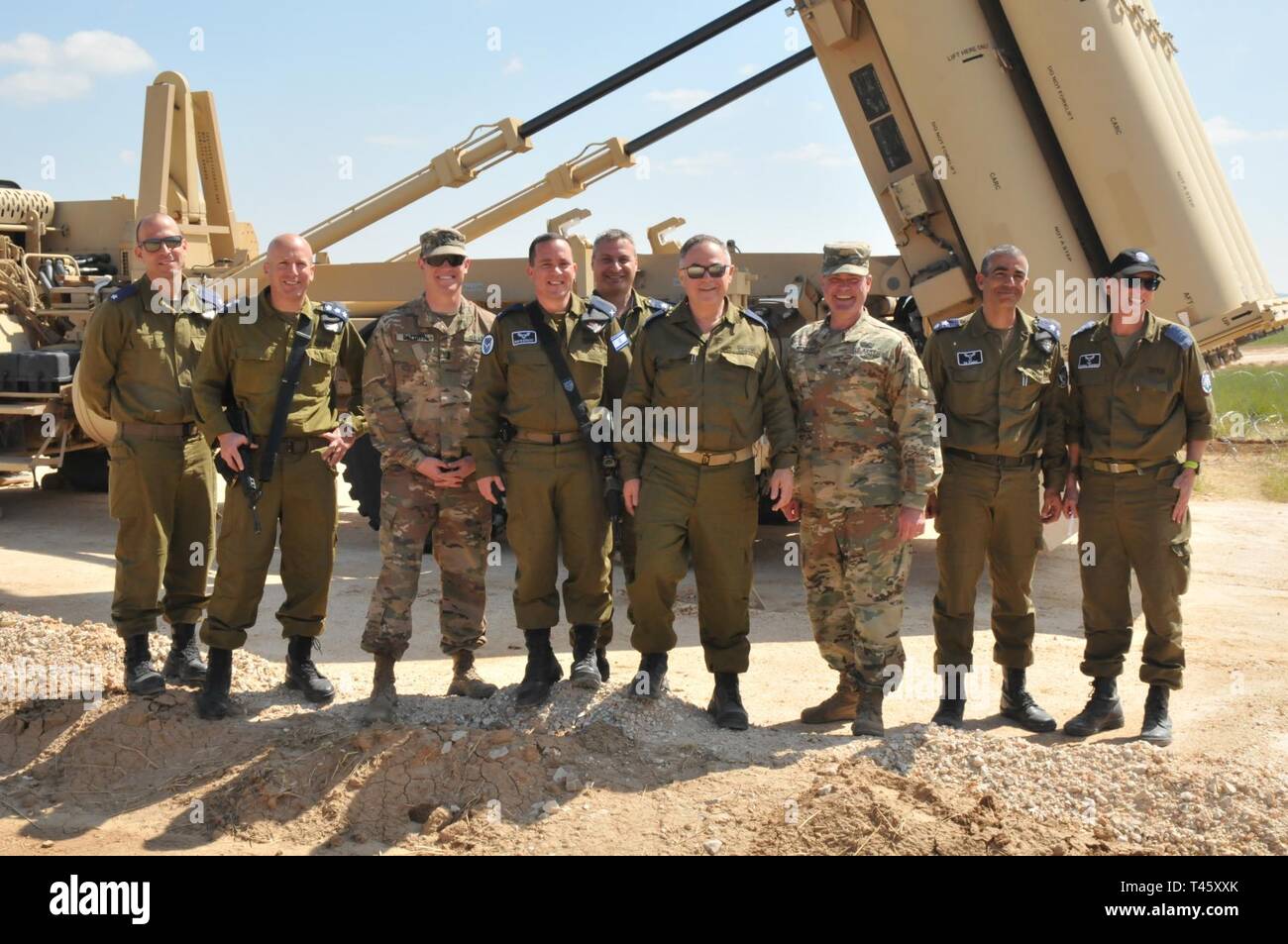 U.S. Army and Israeli senior leaders pose for a photo in front of a Terminal High Altitude Area Defense launcher Mar. 11, 2019 during a visit at a THAAD site in Israel. During their visit, they toured the site and met with senior leaders. Stock Photo