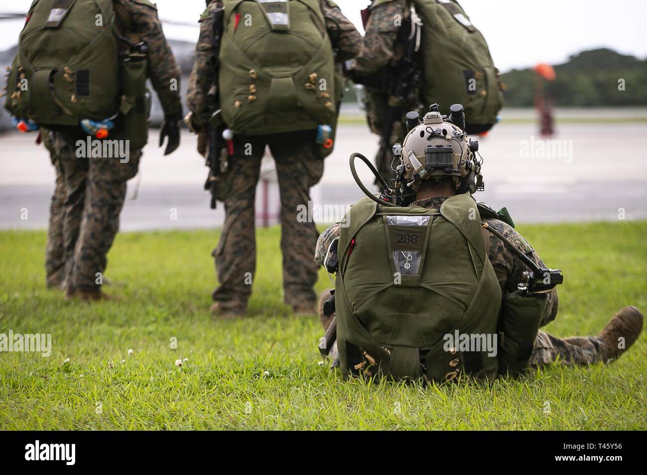 Marines with the 31st Marine Expeditionary Unit's Maritime Raid Force wait to board a helicopter before a military free-fall jump during simulated Expeditionary Advanced Base Operations, Marine Corps Air Station Futenma, Okinawa, Japan, March 11, 2019. Marines with the 31st MEU are conducting simulated EABO in a series of dynamic training events to refine their ability to plan, rehearse and complete a variety of missions. During EABO, the 31st MEU partnered with the 3rd Marine Division, 3rd Marine Logistics Group and 1st Marine Aircraft Wing, and airmen with the U.S. Air Force 353rd Special Op Stock Photo