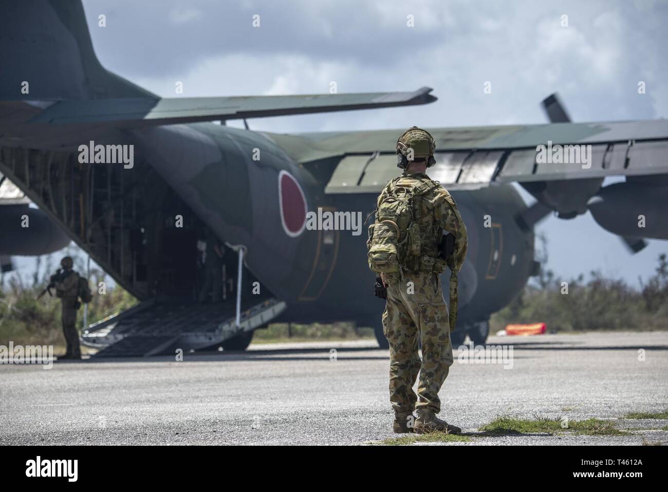 Royal Australian Air Force security force members provide security on the flight line at Tinian, U.S. Commonwealth of the Northern Marianas Islands during Cope North Feb. 27, 2019. Cope North is an annual multilateral U.S. Pacific Air Forces-sponsored field training exercise focused on combat air forces large-force employment and mobility air forces humanitarian assistance and disaster relief training to enhance interoperability among U.S., Australian and Japanese forces. Stock Photo