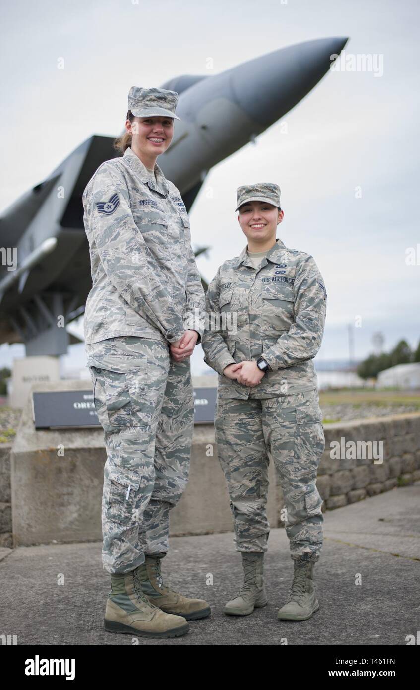 Staff Sgt. Taylor Ingersoll and Airman 1st Class Olivia Cappelli pose in  front of an f-15 static display, Portland Air National Guard Base, Oregon,  February 27, 2019. Both Airmen work as Weapons