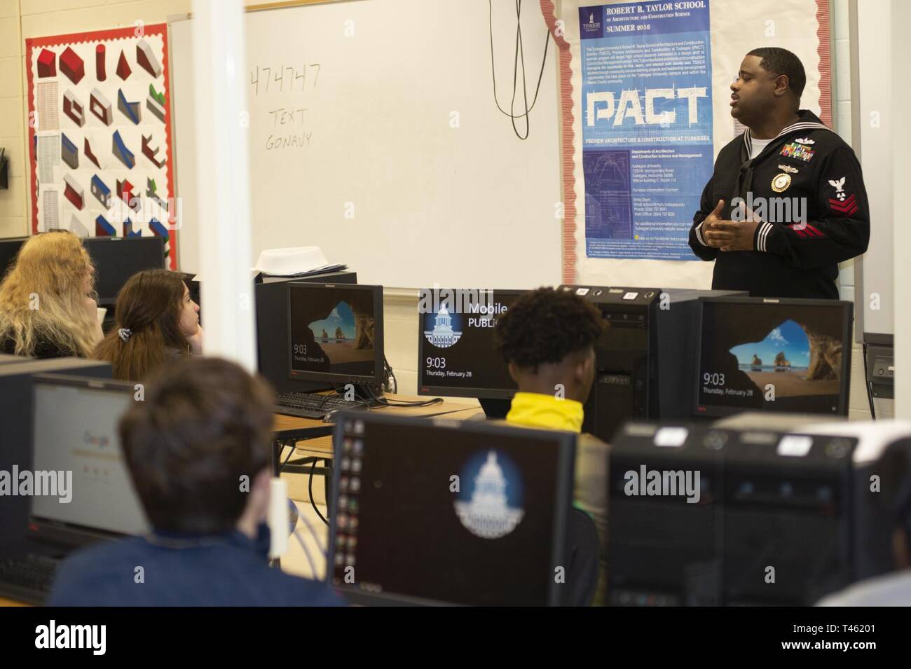 Ala. (Feb 28, 2019) Machinist's Mate 1st Class Jermain Evans, a Navy Recruiting District Houston recruiter, speaks to students of Theodore High School during Navy Recruiting Command's “Swarm” Mobile evolution. Recruiters from Navy Recruiting Command and Navy Talent Acquisition Group New Orleans, along with the Navy’s virtual reality asset, the Nimitz, compile a “Swarming Team,” which is a new recruiting strategy in support of the national policy to build a 355-ship Navy. Stock Photo