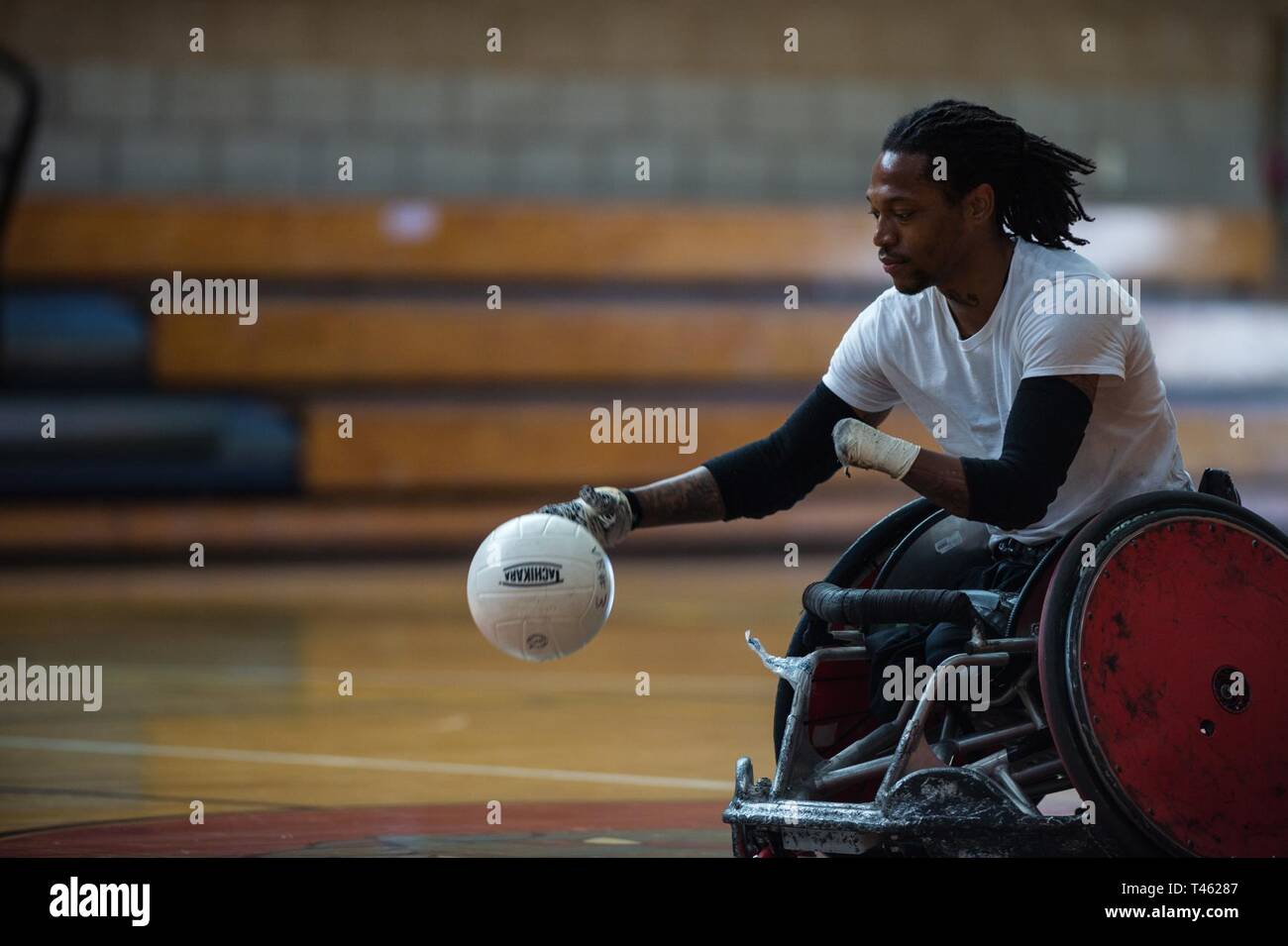 Wheelchair Rugby Coach Anthony McDaniel demonstrates rugby techniques during the 2019 Marine Corps Trials at Marine Corps Base Camp Pendleton, California, Feb. 28.  The Marine Corps Trials promotes recovery and rehabilitation through adaptive sports participation and develops camaraderie among recovering service members and veterans. Additionally, the competition is an opportunity for participants to demonstrate physical and mental achievements and serves as the primary venue to select Marine Corps participants for the DoD Warrior Games. Stock Photo
