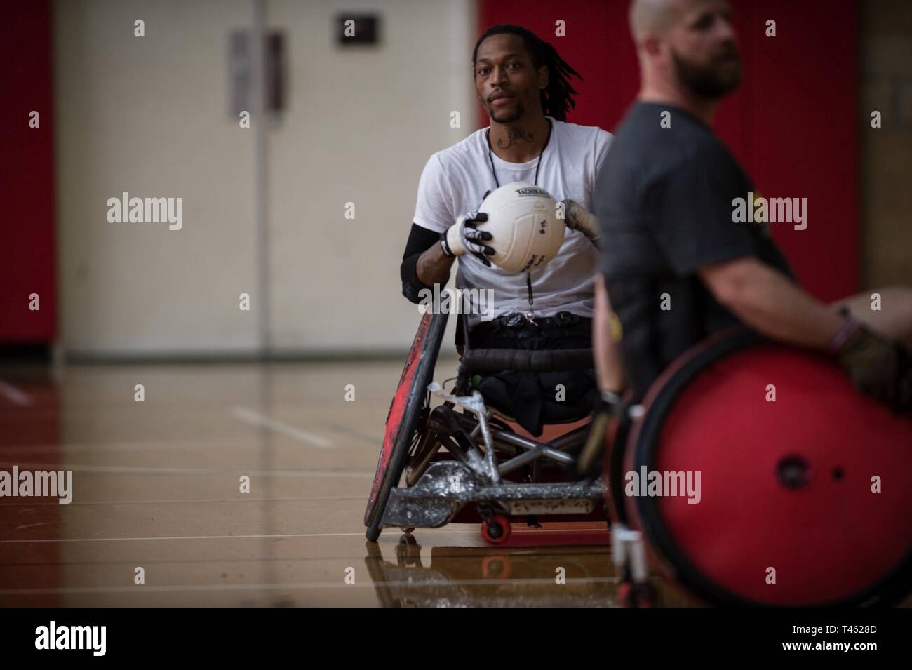 Wheelchair Rugby Coach Anthony McDaniel demonstrates wheelchair rugby techniques during the 2019 Marine Corps Trials at Marine Corps Base Camp Pendleton, California, Feb. 28. The Marine Corps Trials promotes recovery and rehabilitation through adaptive sports participation and develops camaraderie among recovering service members and veterans. Additionally, the competition is an opportunity for participants to demonstrate physical and mental achievements and serves as the primary venue to select Marine Corps participants for the DoD Warrior Games. Stock Photo