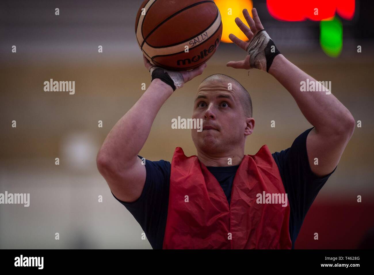 A U.S. Marine Corps athlete shoots a basketball during the 2019 Marine Corps Trials at Marine Corps Base Camp Pendleton, California, Feb. 28. The Marine Corps Trials promotes recovery and rehabilitation through adaptive sports participation and develops camaraderie among recovering service members and veterans. Additionally, the competition is an opportunity for participants to demonstrate physical and mental achievements and serves as the primary venue to select Marine Corps participants for the DoD Warrior Games. Stock Photo
