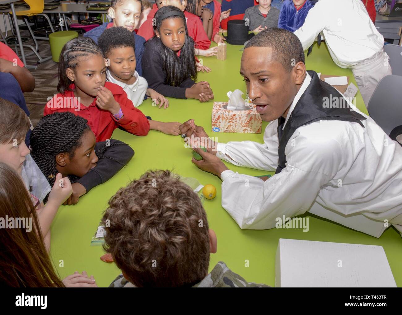 Ala. (Feb. 27, 2019) Personnel Specialist Seaman Jordan A. Young, from Red Oak, Texas, assigned to USS Constitution, shows students at Kate Shepard Elementary School in Mobile, Alabama, the food an 'Old Ironsides' sailor would eat in 1812 during Mobile Alabama Navy Week. Mobile is one of the select cities to host a 2019 Navy Week, a week dedicated to raising U.S. Navy awareness through local outreach, community service and exhibitions. Stock Photo