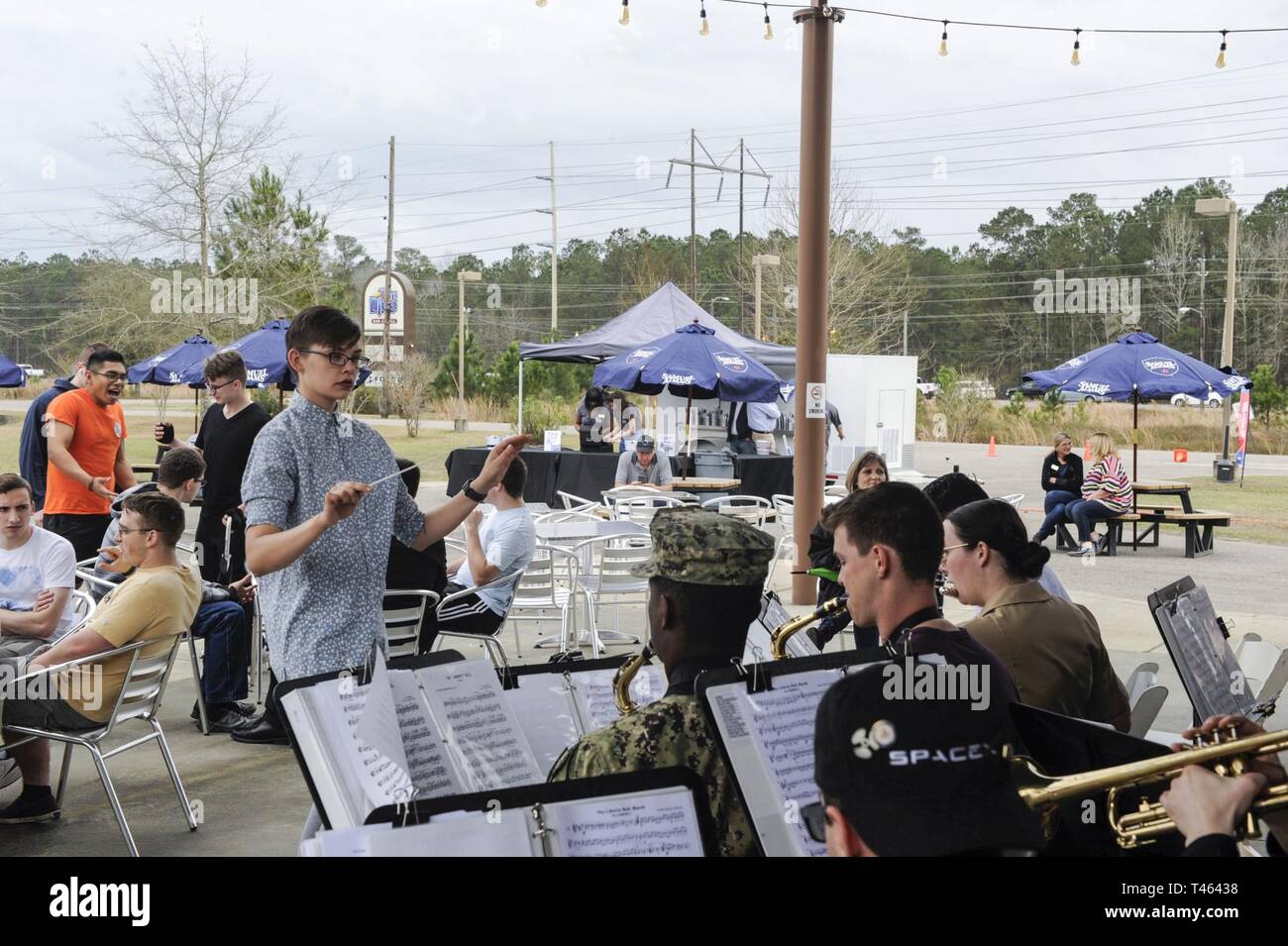 Seaman Briana Buchholtz, Navy Nuclear Power Training Command band conductor, leads the band in a performance during The Dive grand reopening ribbon cutting ceremony March 1, 2019, on the Naval Weapons Station. The Dive shut down in April 2018 for renovations and upgrades. The new and improved facility offers more space and services, food and beverage options and a stage for local bands to perform. Stock Photo