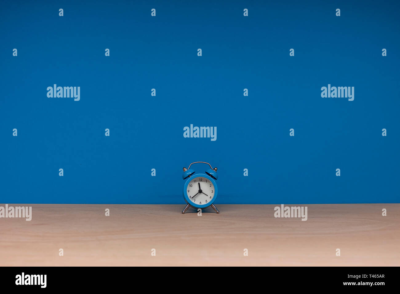 lonely blue alarm clock on paper background Stock Photo - Alamy