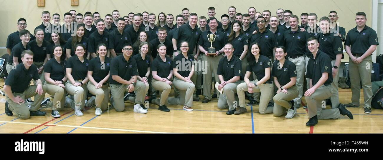 MOSCOW, Idaho – Naval Reserve Officers Training Corps (NROTC) midshipmen, officer candidates and Marine Enlisted Commissioning Education Program (MECEP) members from the University of Washington gather around their commanding officer and professor of Naval Science, U. S. Navy Capt. Michael Lockwood (center), after accepting the overall trophy for winning the annual 2019 Northwest Navy Competition at the University of Idaho March 2. More than 270 NROTC students from the Universities of Idaho/Washington State, Utah, Oregon State, and Washington competed in military drill, academic and athletic e Stock Photo