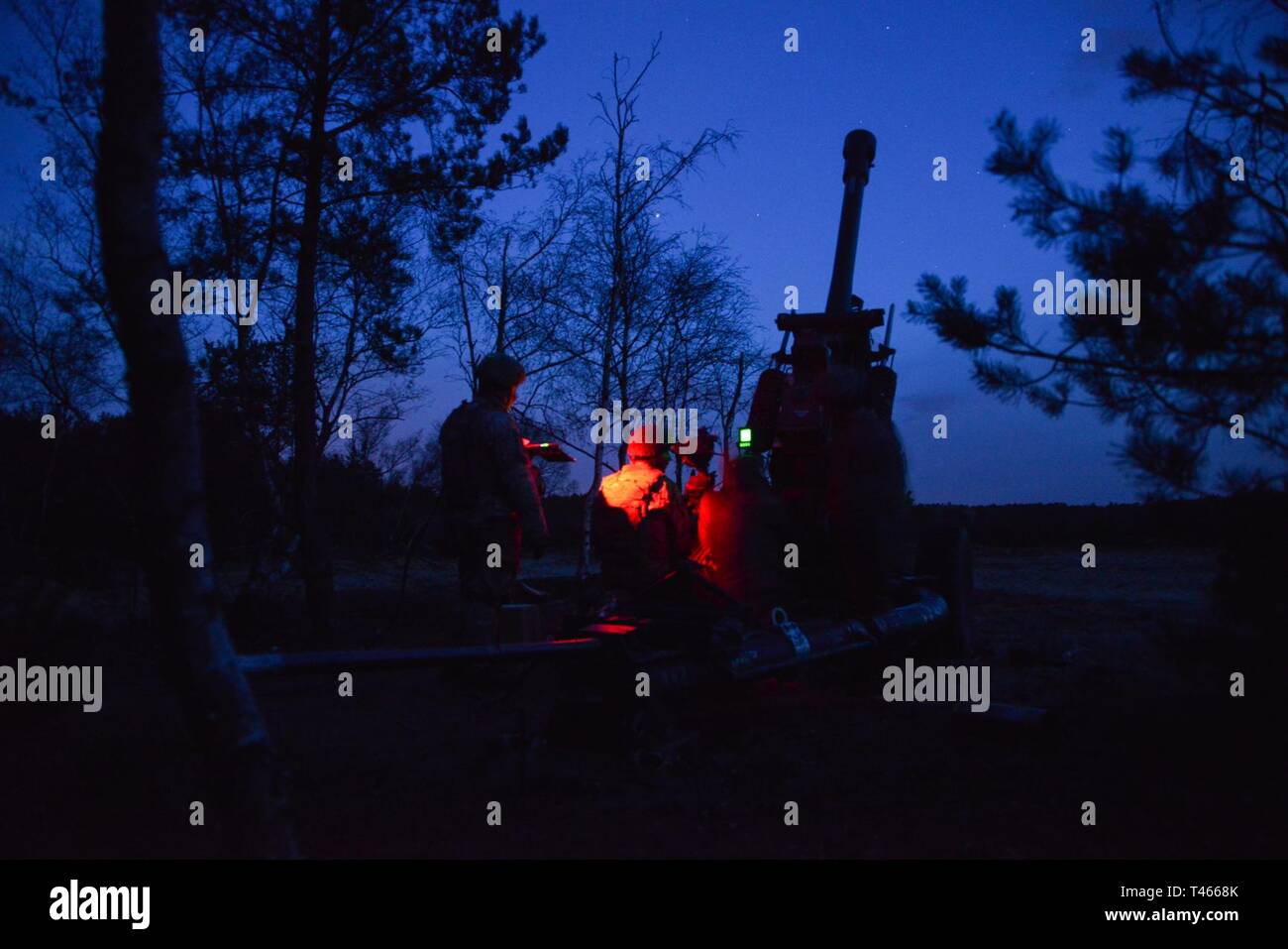 U. S. paratroopers assigned to A Battery, 4th Battalion, 319th Airborne Field Artillery Regiment, 173rd Airborne Brigade prepare to fire a M119 105 mm howitzer during exercise Dynamic Front 2019 at Torun, Poland, March 4, 2019. Exercise Dynamic Front 19 includes approximately 3,200 service members from 27 nations who are observing or participating from Grafenwoehr Training Area, Germany; Riga, Latvia; and Torun, Poland; during March 2-9, 2019. Dynamic Front is an annual U.S. Army Europe exercise focused on the readiness and interoperability of U.S. Army, joint service, and allied and partner n Stock Photo