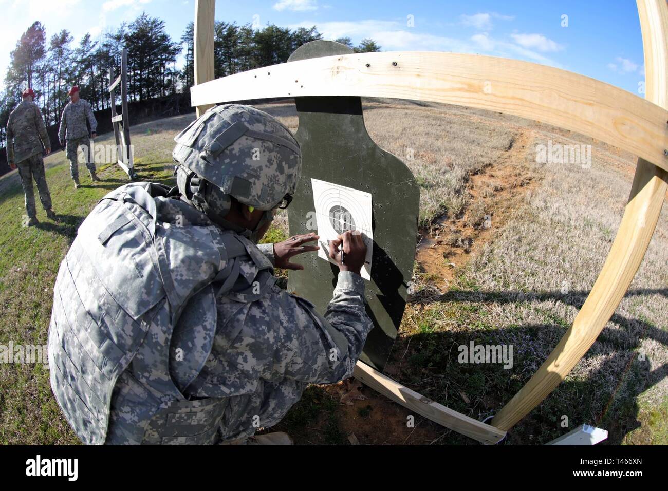 Spc. Alizi Douglas, assigned to the 130th Maneuver Enhancement Brigade,  marks his shot group after firing an M4 carbine assault rifle during the  2019 Best Warrior Competition at the Camp Butner Training