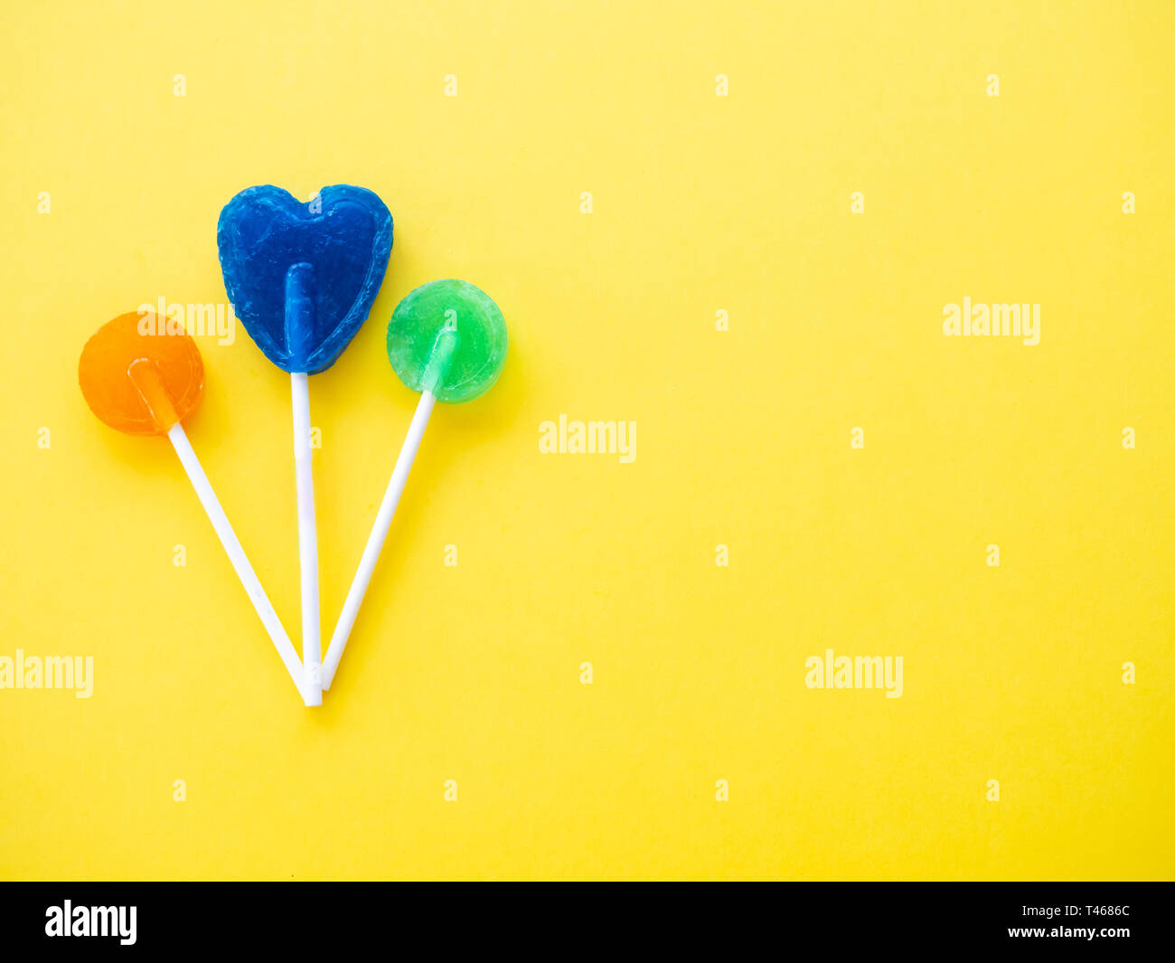 Several lollipops on a yellow background Stock Photo