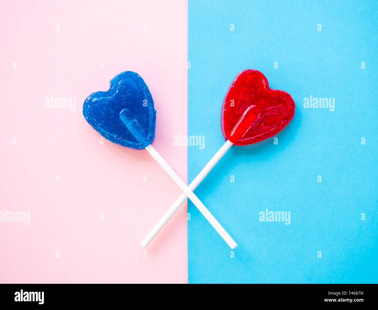 Red and blue lollipops on a pink and blue background Stock Photo
