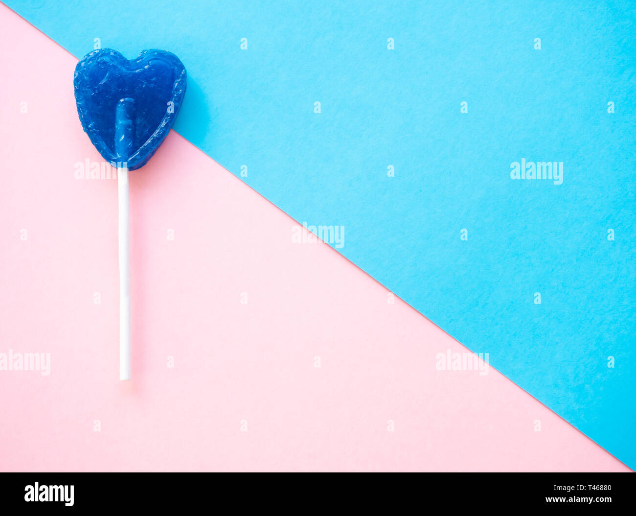 Blue lollipop on a pink and blue background Stock Photo