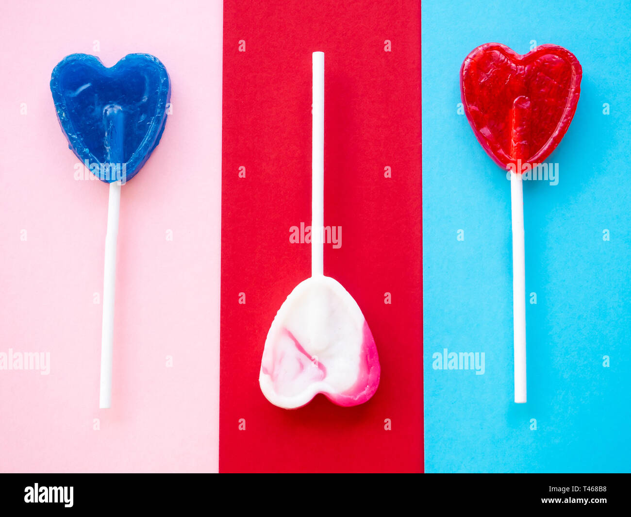 Several lollipops on a red, pink and blue background Stock Photo