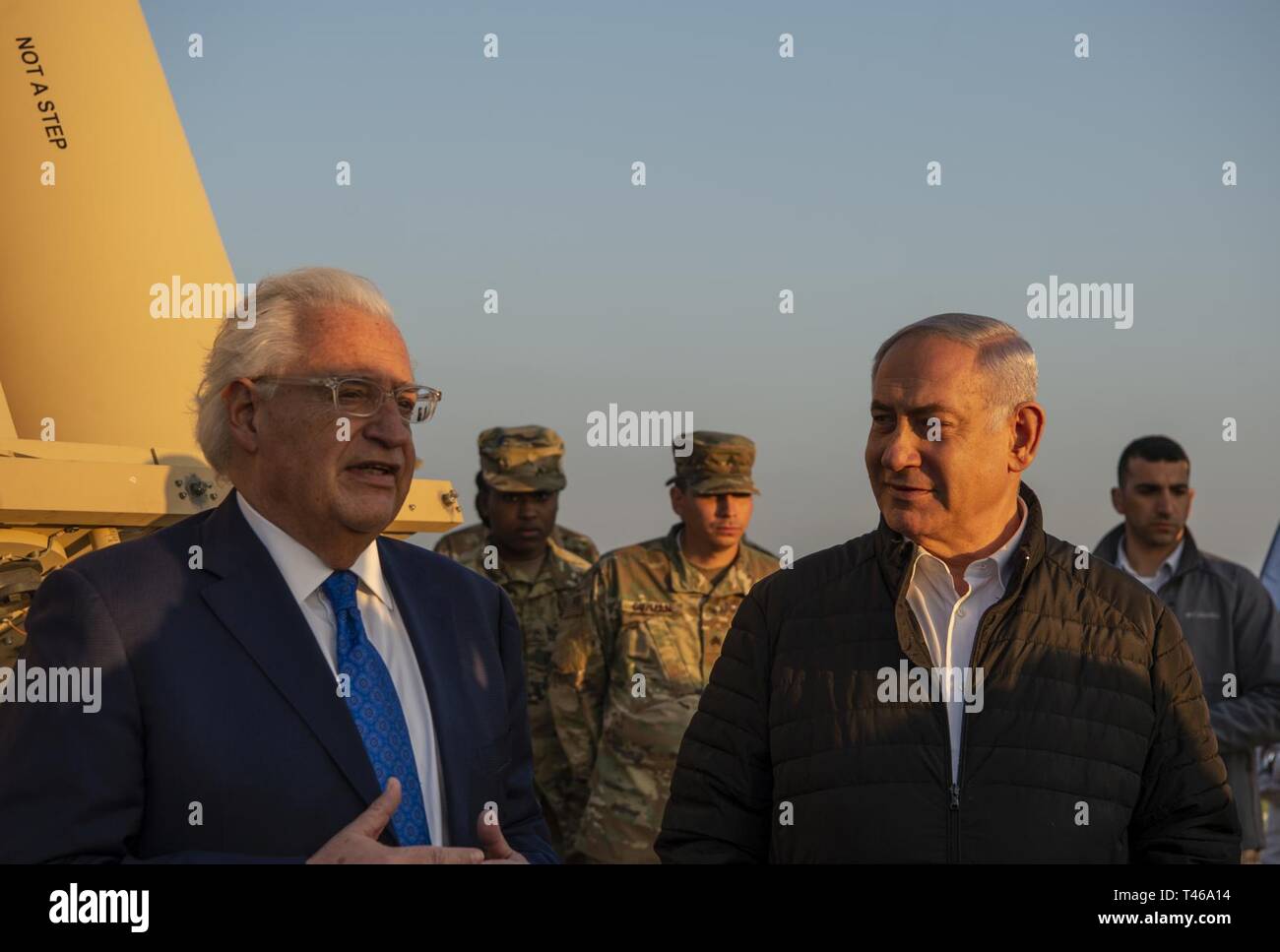 Israeli Prime Minister (right), Benjamin Netanyahu, and David M. Friedman, the United States Ambassador to Israel, speak during a visit to the Terminal Altitude Area Defense System site in Israel on March 6.   The deployment of a THAAD System to Israel is an exercise involving U.S. Army, U.S. Air Force and Israeli forces, under the Dynamic Force Employment concept. The exercise builds readiness and interoperability in the region, demonstrates the U.S. capability to rapidly deploy air defense assets globally, and demonstrates U.S. Army Europe's mission to deter potential adversaries and support Stock Photo