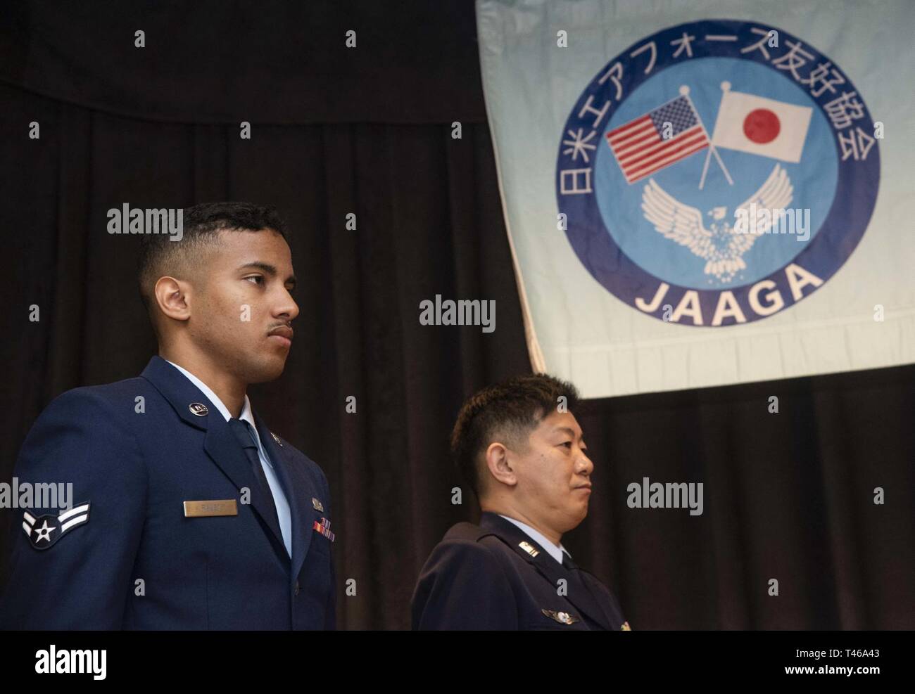 U.S. Air Force Airman 1st Class William Raley, left, a 610th Air Control Flight weapons director technician, and Japan Air Self-Defense Force Tech. Sgt. Shigeru Aihata, right, a 6th Air Defense Missile Group supply management section chief, prepare to receive the Japan-America Air Force Goodwill Association award at Misawa Air Base, Japan, March 6, 2019. The JAAGA awards happen annually, honoring the top JASDF and U.S. Air Force member who best contributes to building U.S.-Japan partnerships. Stock Photo