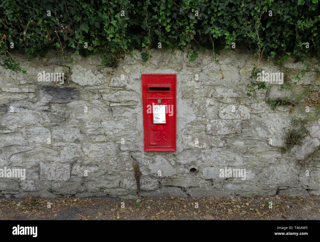 Red wall mounted  Royal Mail letter post collecting box, St Mawes, Cornwall, England Stock Photo