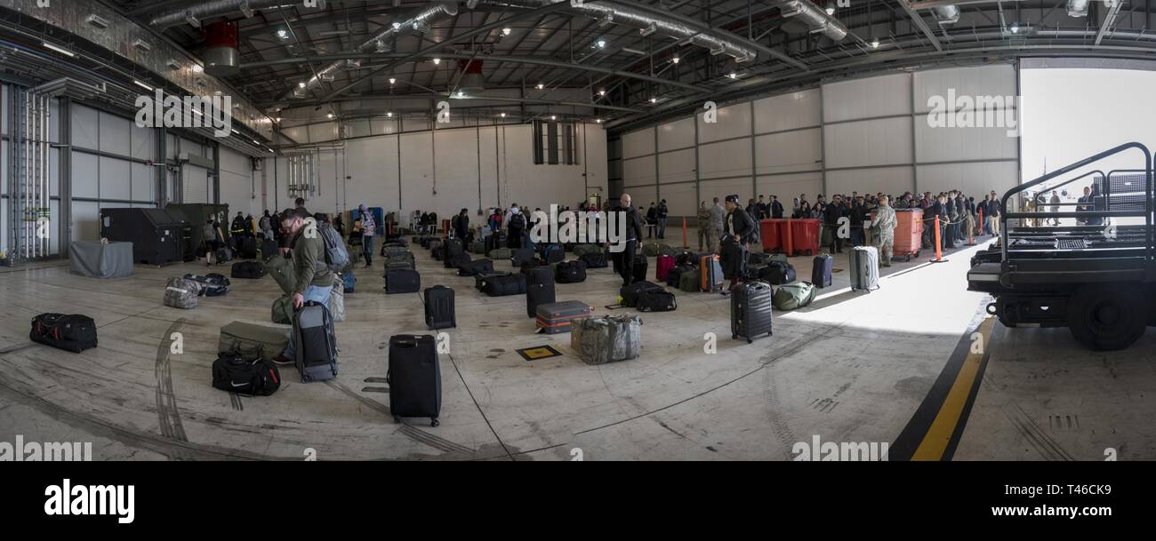 Airmen deployed from Barksdale Air Force Base, La.,inprocess and pick up their luggage upon arriving at RAF Fairford, England, March 11, 2019. Inprocessing took about an hour and included customs, billeting assignments and transportation for their deployment supporting U..S. Strategic Command’s Bomber Task Force in Europe. Stock Photo