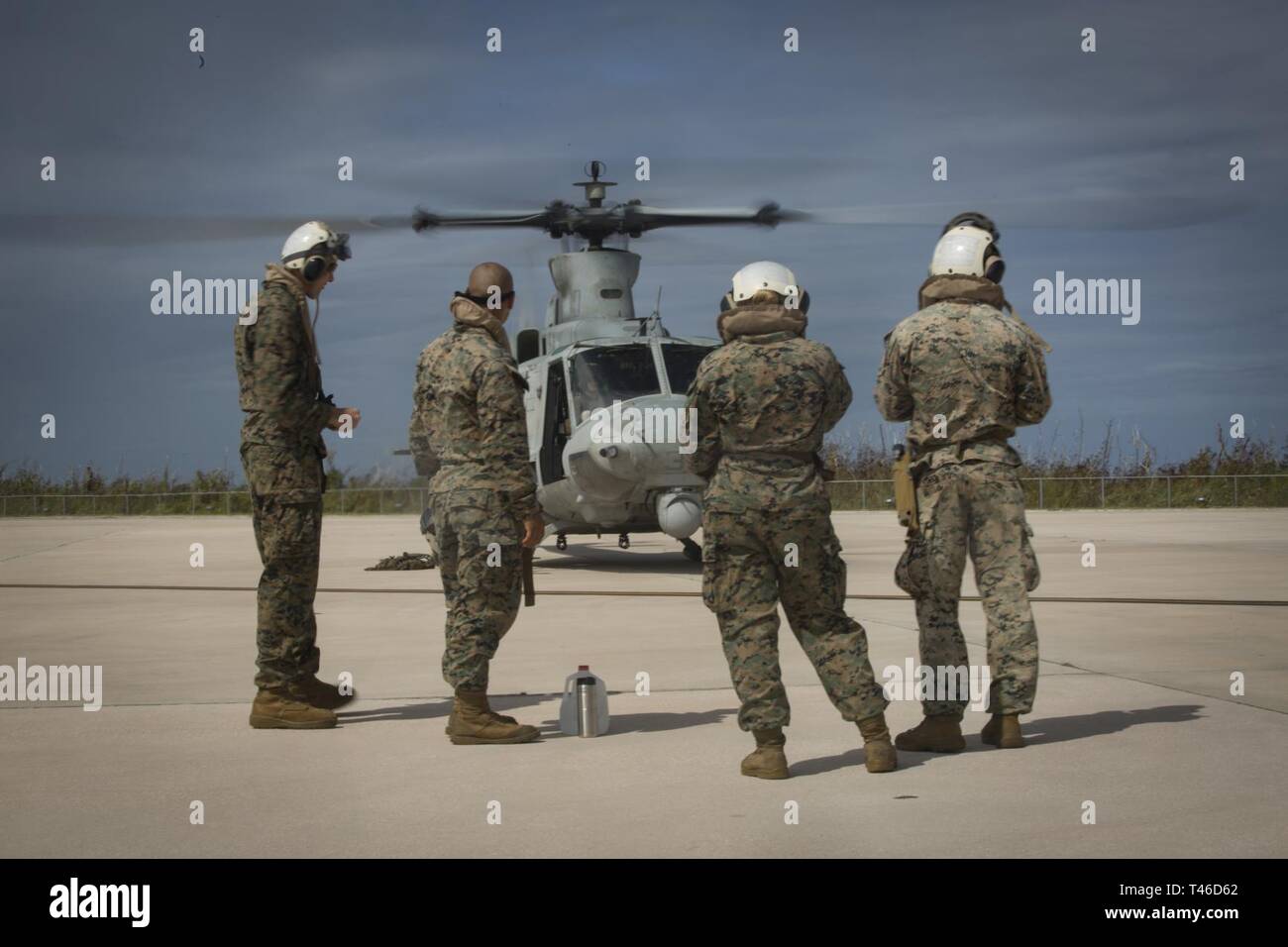 Marines with Combat Logistics Battalion 31 and Alpha Company, Battalion Landing Team, 1st Battalion, 4th Marines, prepare to board a UH-1Y Huey helicopter at Anderson Air Force Base, Guam, before a visit to Tinian, Commonwealth of the Northern Mariana Islands, March 11, 2019. Marines and Sailors with CLB-31 led a multi-service task force, partnering with the Federal Emergency Management Agency, to help the U.S. citizens of Tinian begin recovery efforts in the wake of Super Typhoon Yutu last year. The Marines and Sailors, currently participating in two weeks of unit-level training on nearby Gua Stock Photo