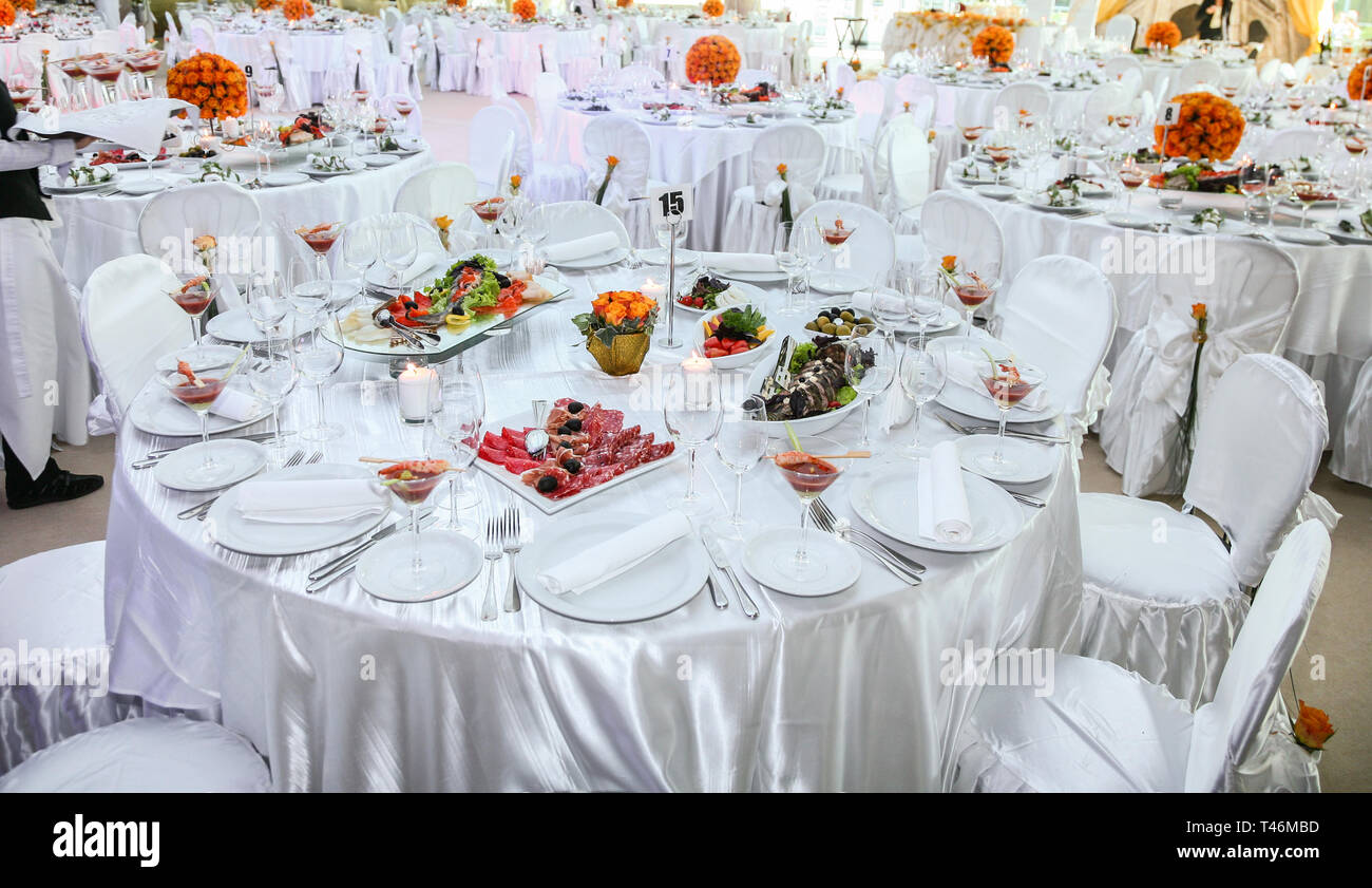 Holiday table setting decorated with flowers and candles Stock Photo ...