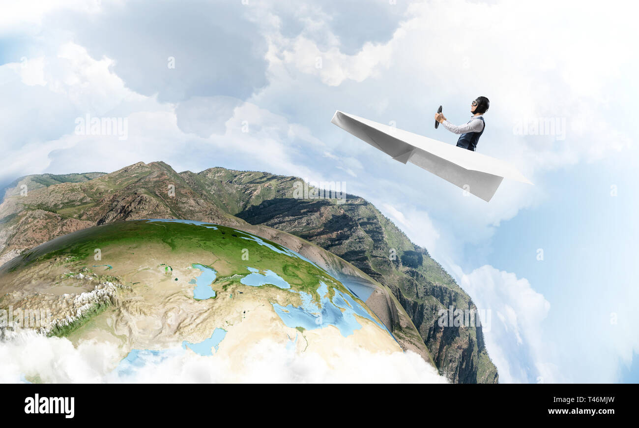 Pilot in leather helmet and goggles driving paper plane on background ...