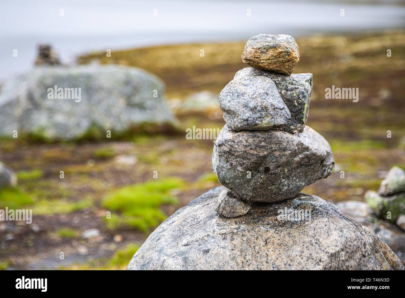 Piled stones are houses for Norwegian fairytale trolls. Troll house made from stones. Tourists are building troll houses out of stones, according to l Stock Photo