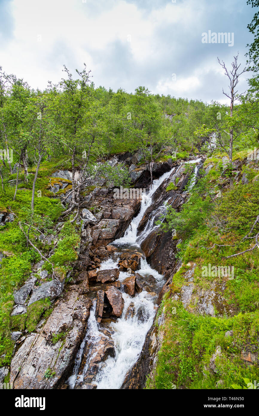 Norway landscape with big waterfall. Waterfall in mountains of Norway. Beautiful Nature Norway natural landscape. Stock Photo