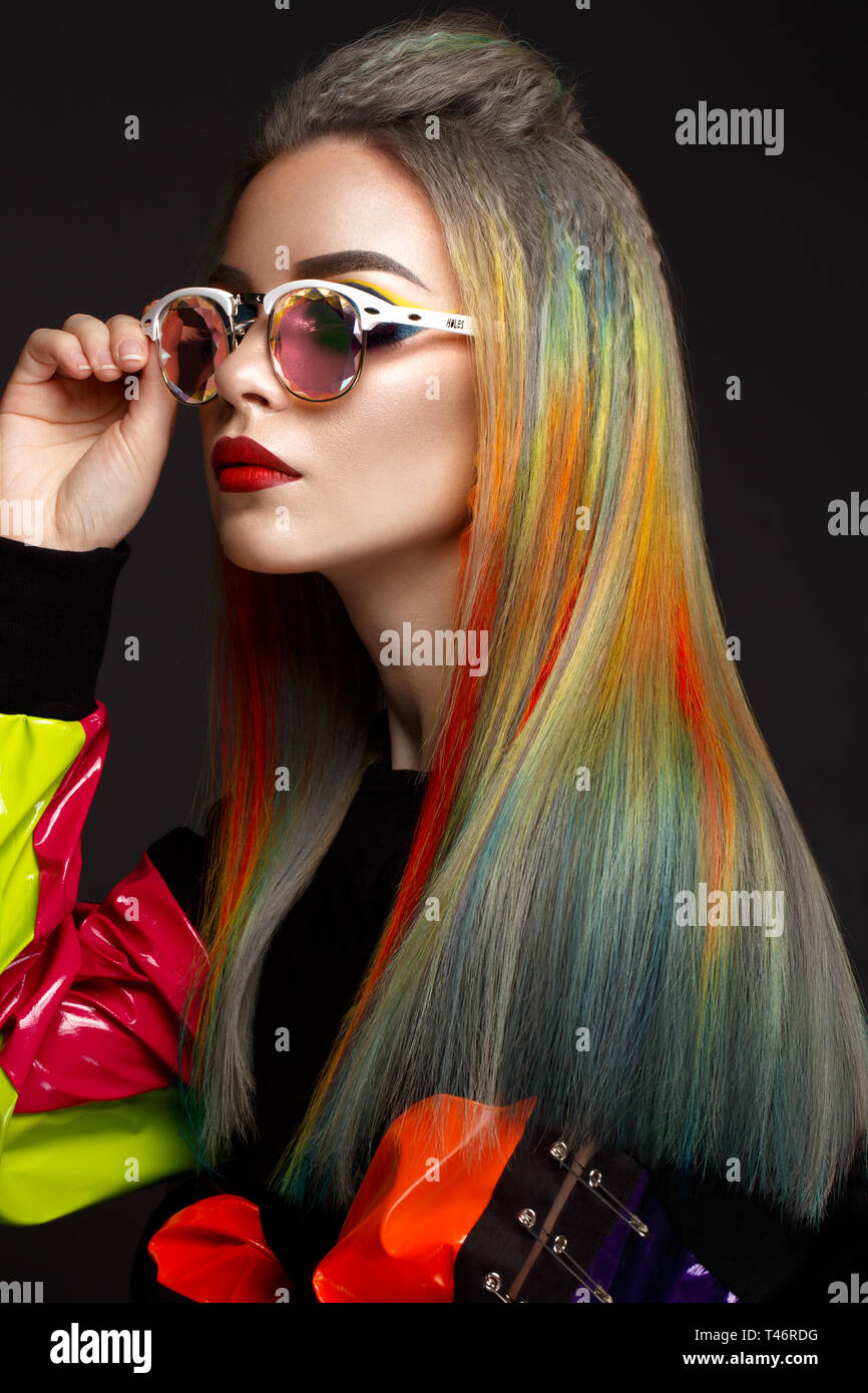 Beautiful girl with multi-colored hair and creative make-up and hairstyle. Beauty face. Stock Photo