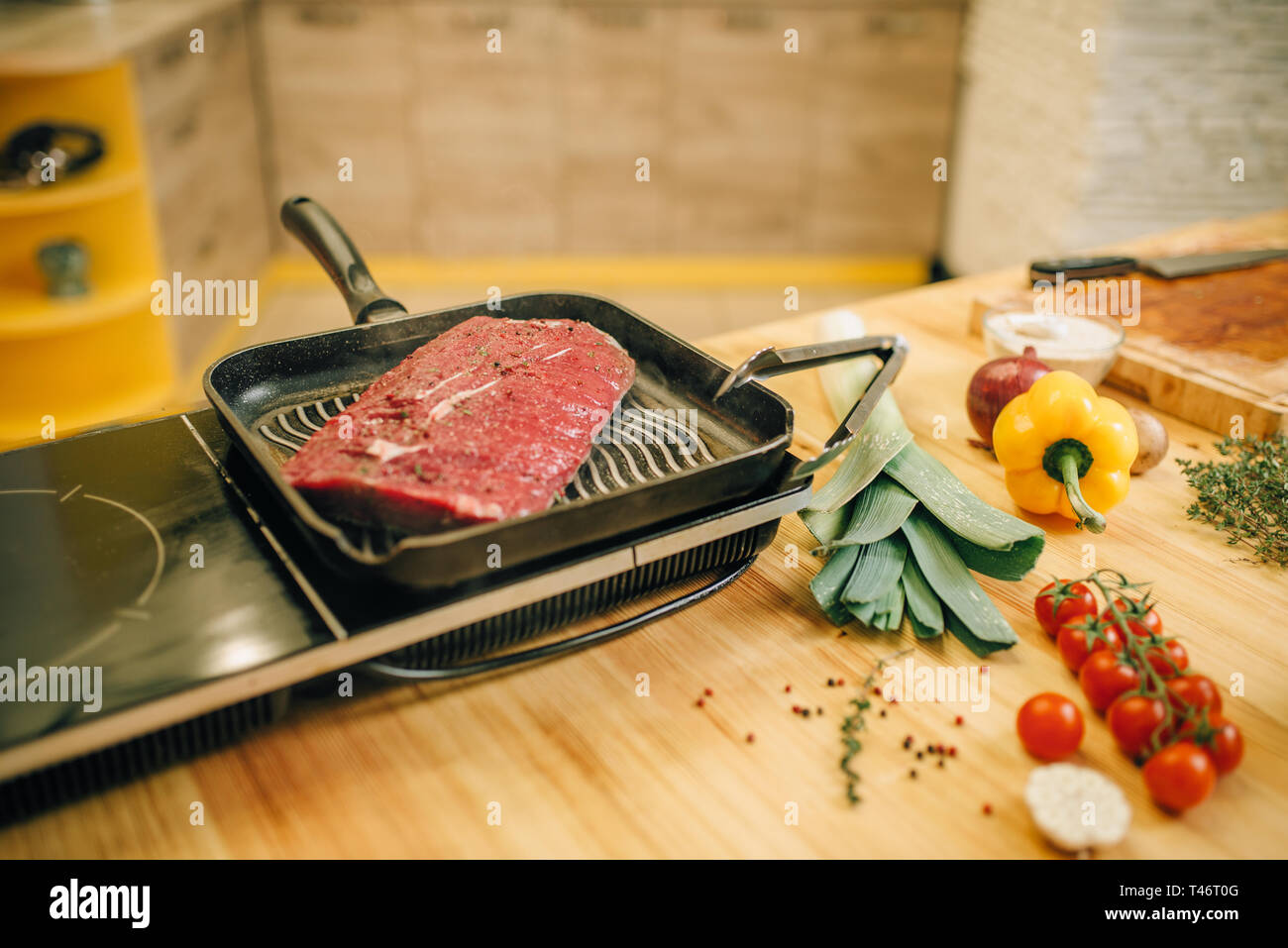 Roasted meat in a frying pan on electric stove Stock Photo Alamy