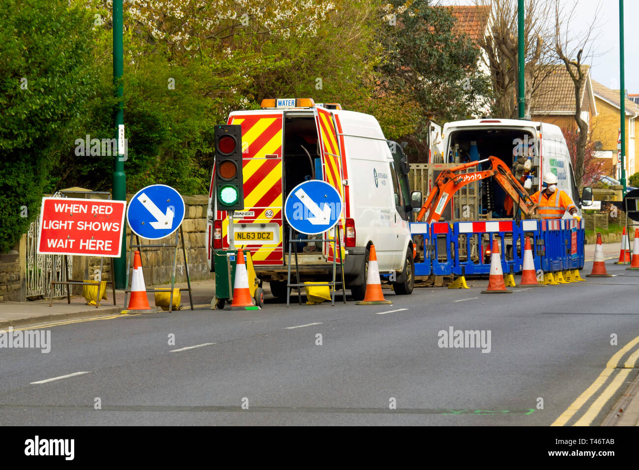 Yorkshire Water contractors connecting a new service in busy road in the Village Centre  Marske by the Sea Cleveland North Yorkshire England UK Stock Photo