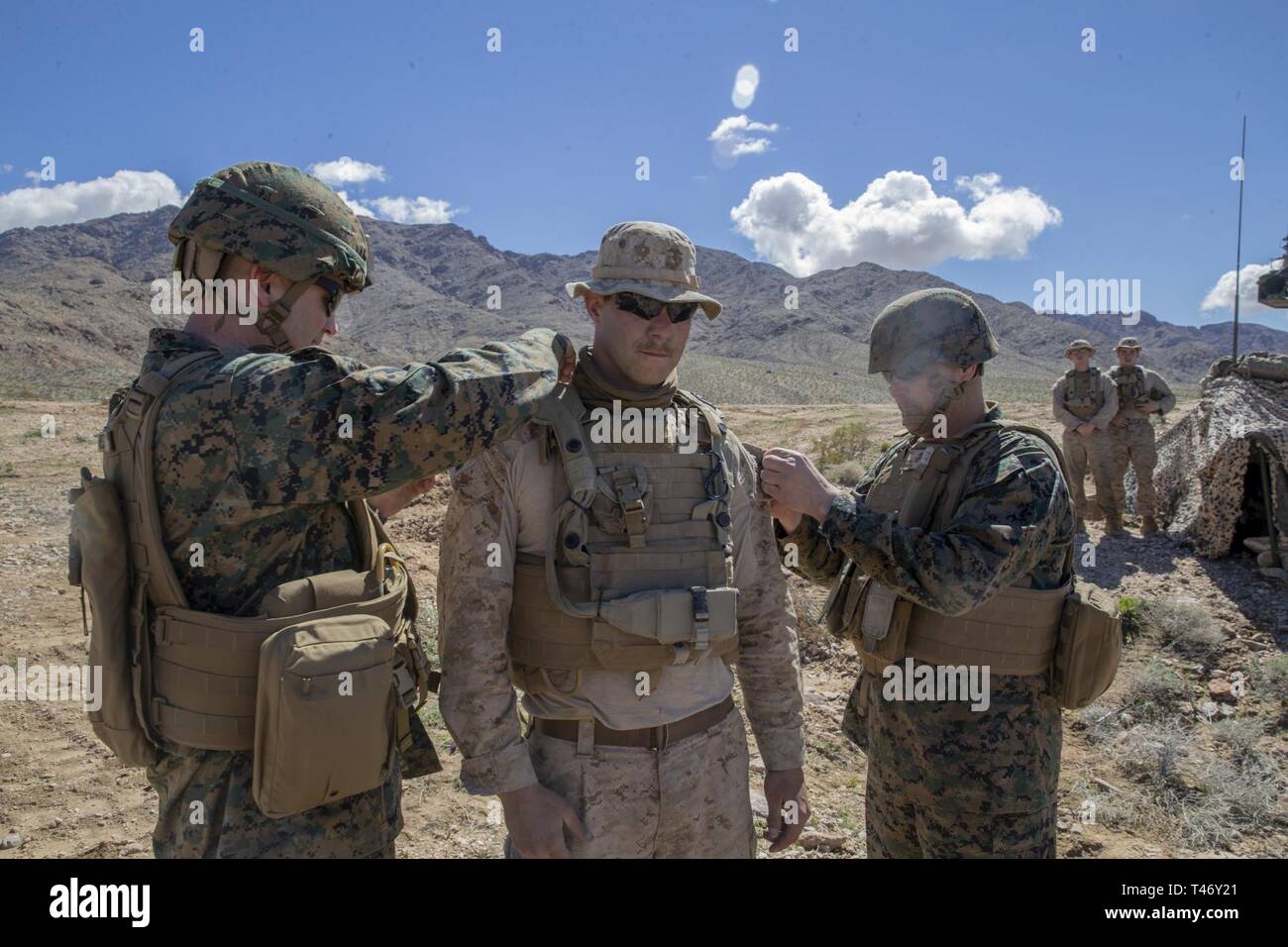 U.S. Marine Maj. Gen. David J. Furness, left, the commanding general, and Sgt. Maj. Alex M. Dobson, the sergeant major, 2nd Marine Division meritoriously promote Lance Cpl. Patrick C. Mulcahy, a section leader with 2nd Light Armored Reconnaissance Battalion, 2nd Marine Division to the rank of Corporal, at Fort Irwin, California, March 12, 2019. Mulcahy was recognized by Maj. Gen. Furness for his superior performance of duties and meritoriously promoted to the rank of Corporal. The Marines of 2d Light Armored Reconnaissance Battalion participated in National Training Center 19-05 as the opposin Stock Photo