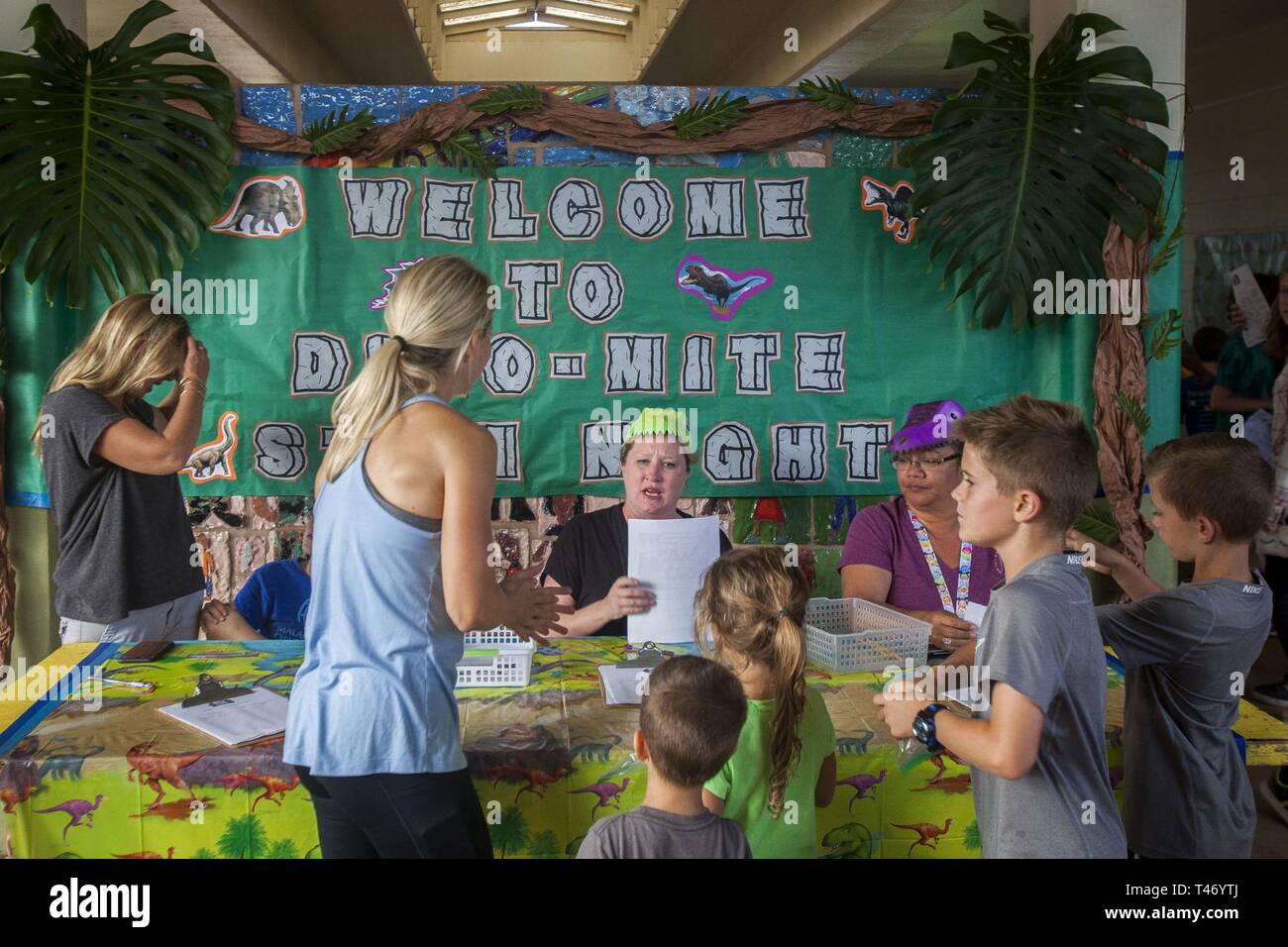A Mokapu Elementary School staff member speaks to a family during the