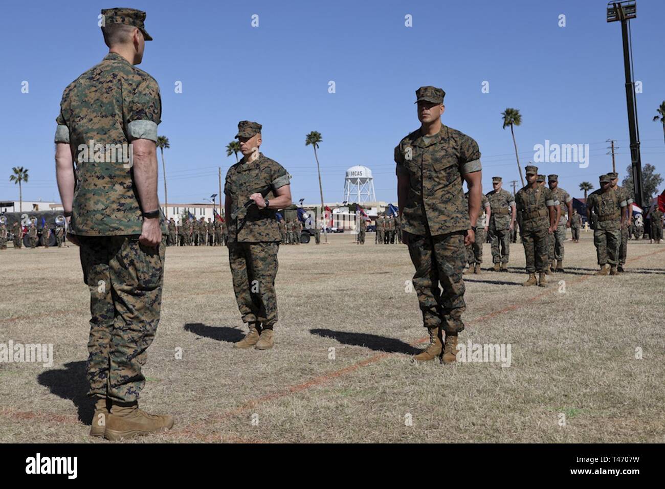 U.S. Marine Corps Sgt. Maj. William Bilenski (Left) and Sgt. Maj. George Hernandez (Right) prepare to exchange the Non-commissioned officer (NCO)  Sword during the Marine Air Control Squadron 1 Relief and Appointment ceremony at Marine Corps Air Station Yuma, Ariz,. March. 13, 2019. The Relief and Appointment ceremony is an honored product of the rich heritage of Naval tradition. The heart of the ceremony is the passing of the organizational Non-commissioned (NCO) Sword by the Activity Commander from the outgoing Sergeant Major to the new Sergeant Major, which signifies the transfer of respons Stock Photo